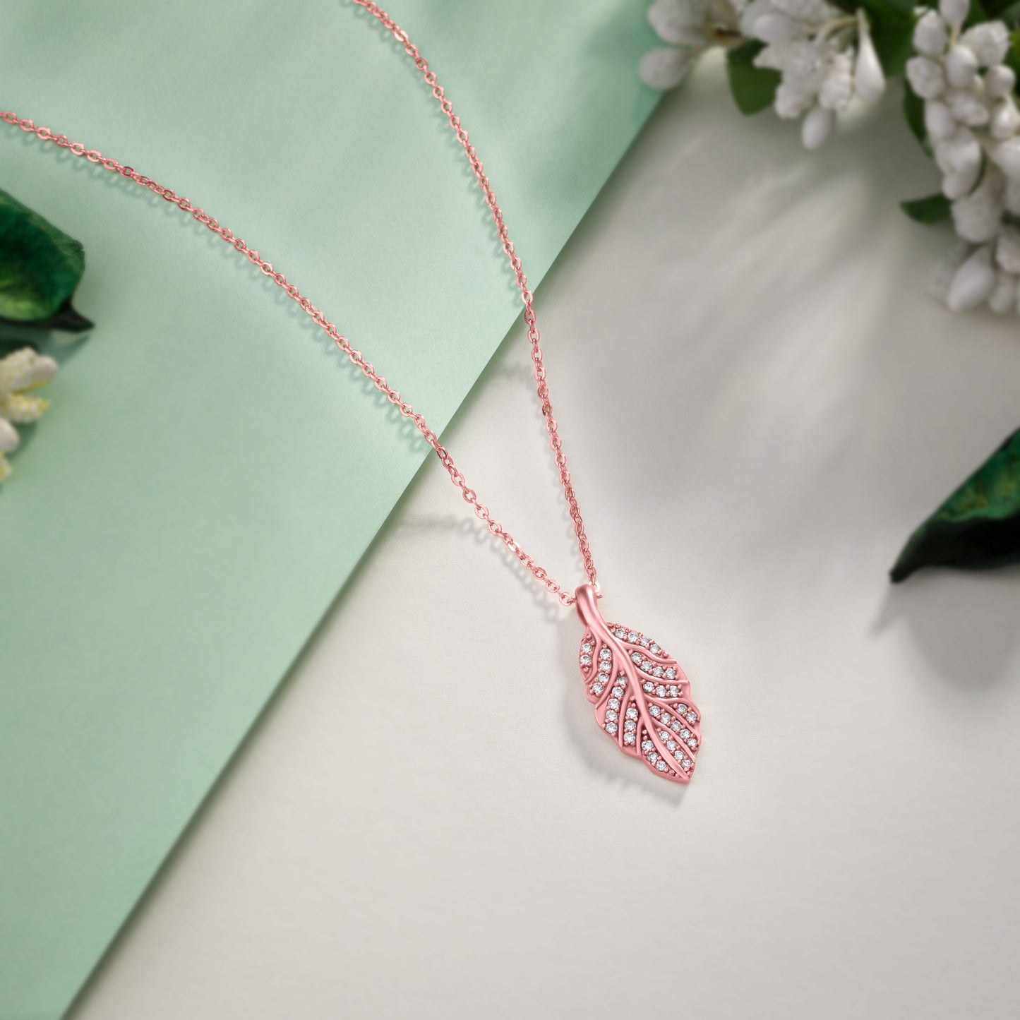 rose gold necklace with a pink diamond leaf pendant