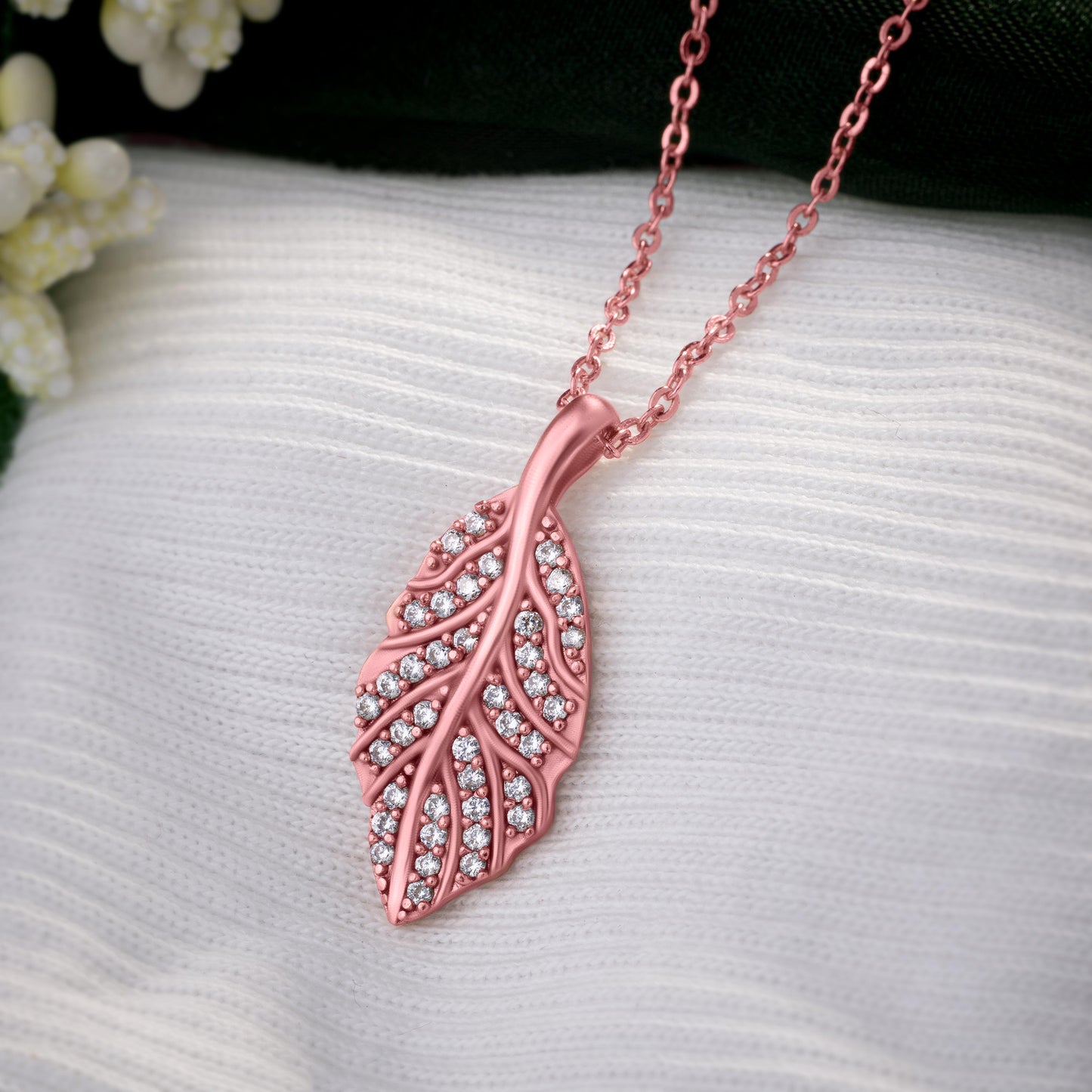 rose gold necklace with a pink diamond leaf pendant