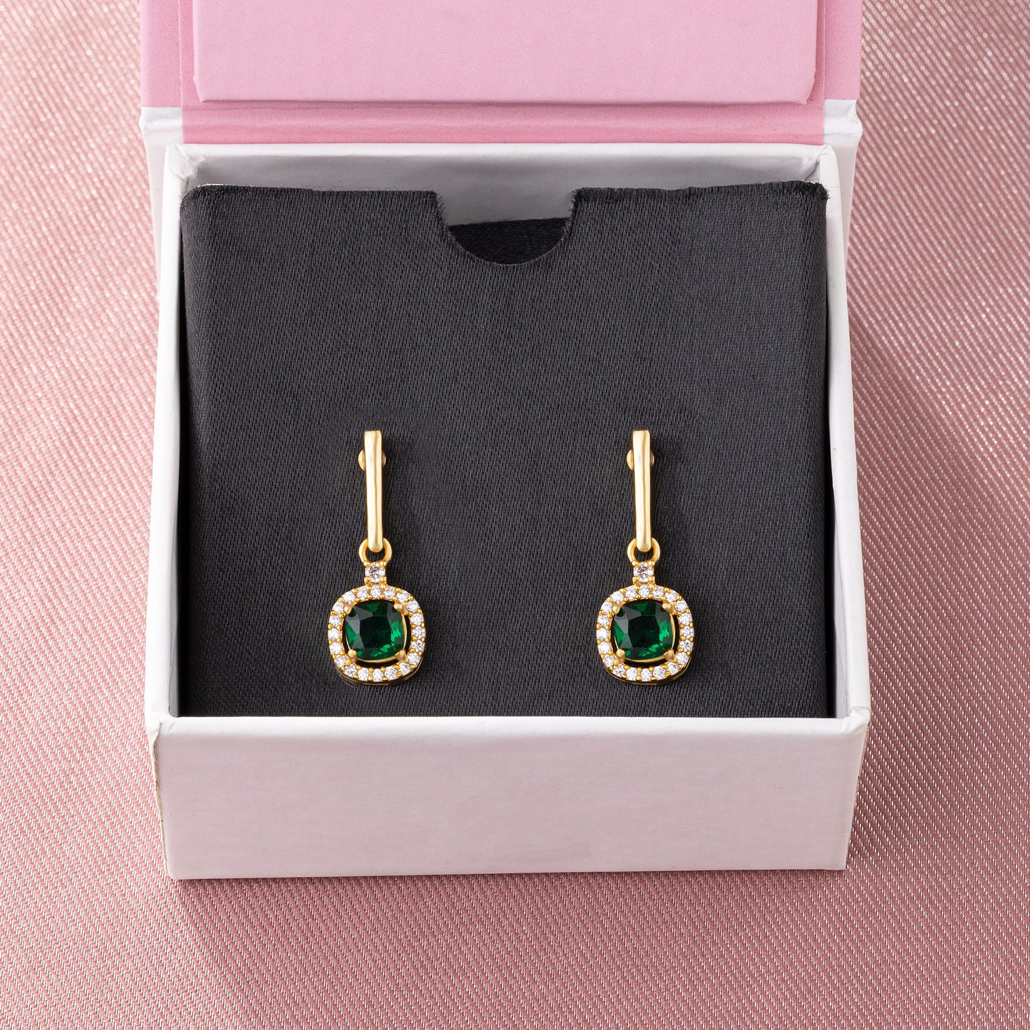 pair of earrings with a ruby stone and diamonds