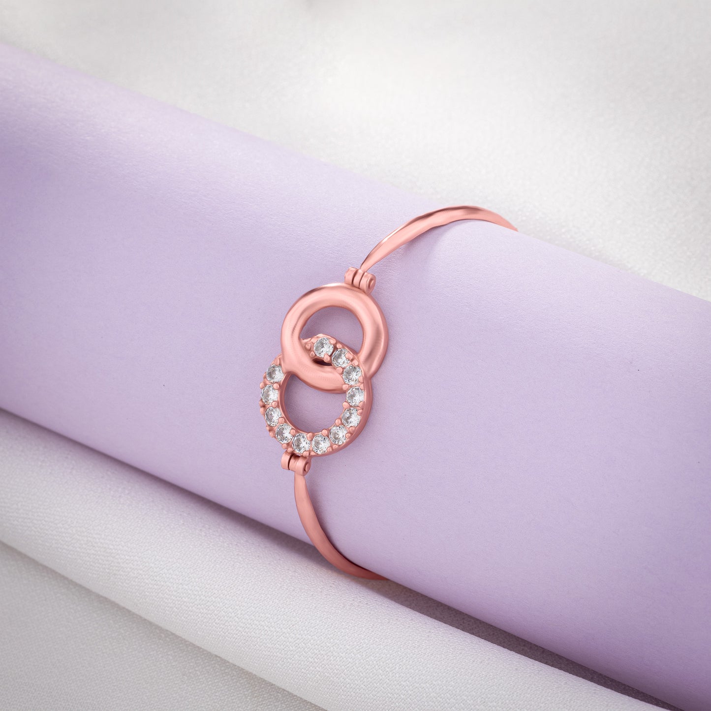 rose gold bracelet with a chain and a crystal stone