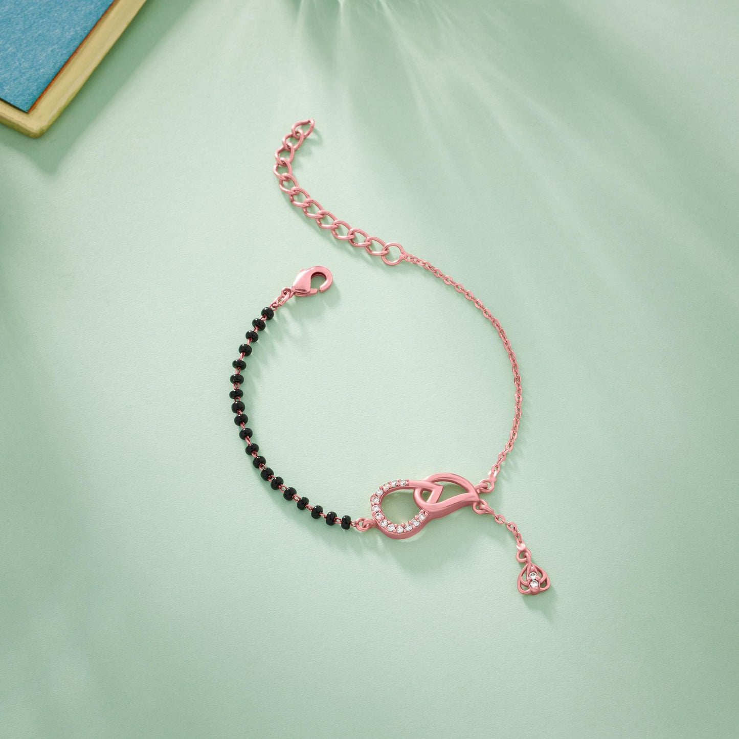 bracelet with a heart charm and a black bea