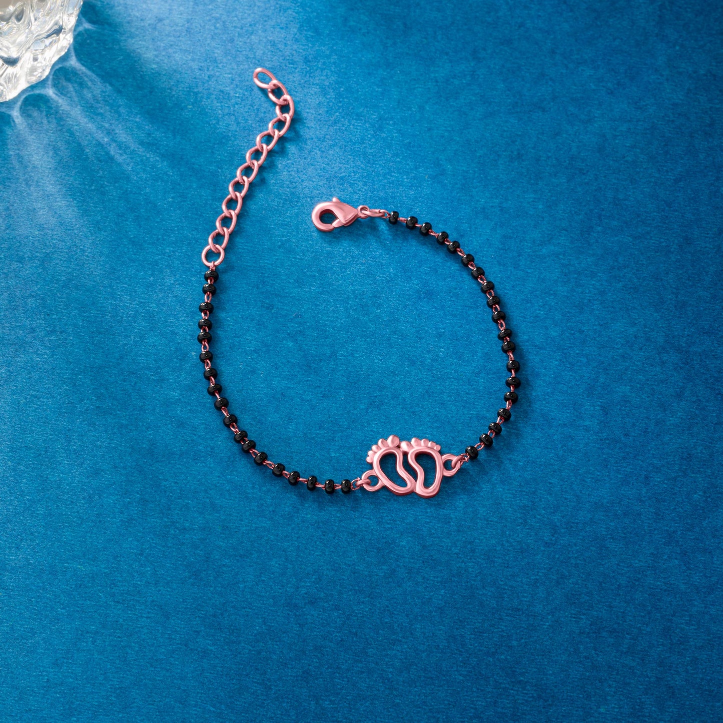 bracelet with a rose gold and black bea