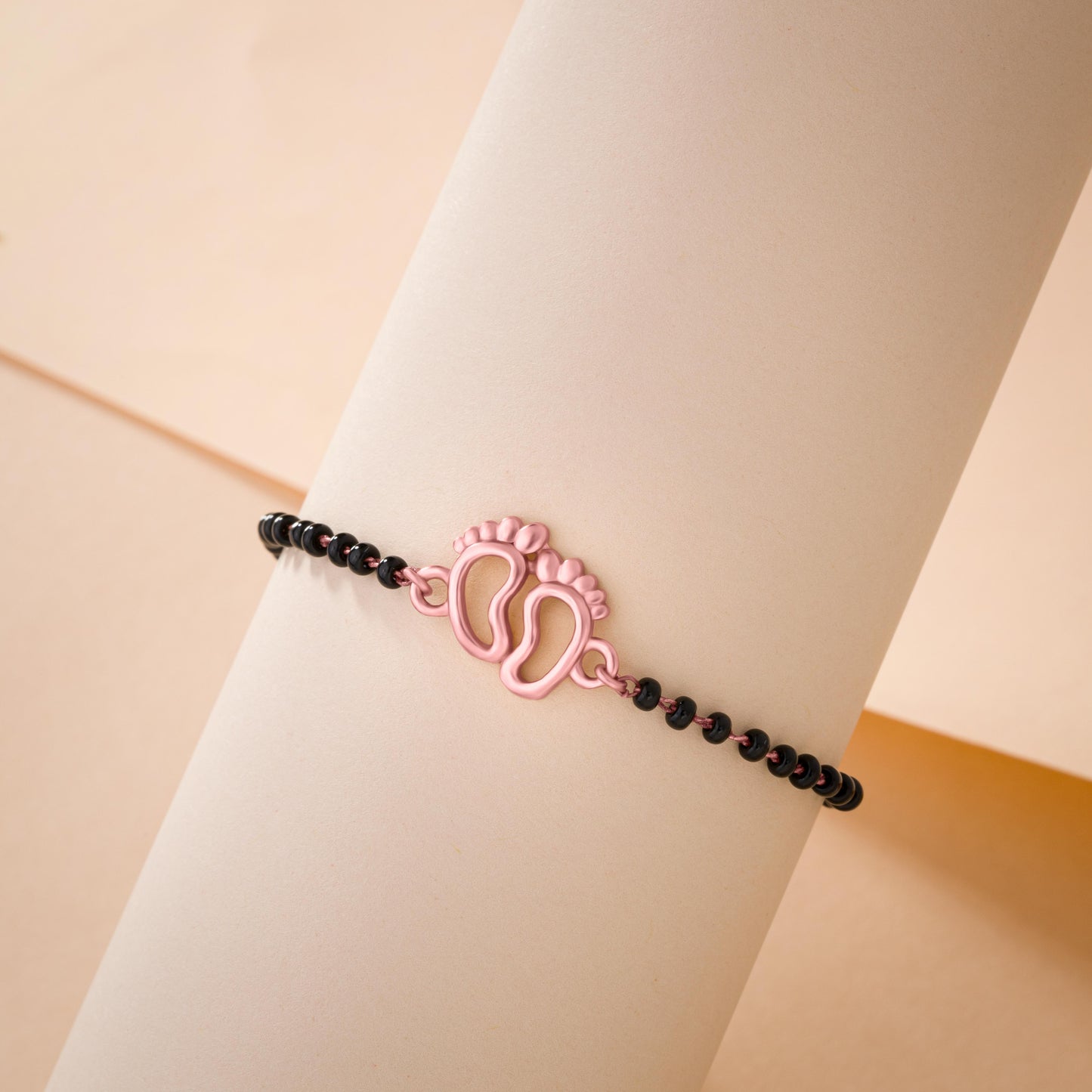 bracelet with a rose gold and black bea