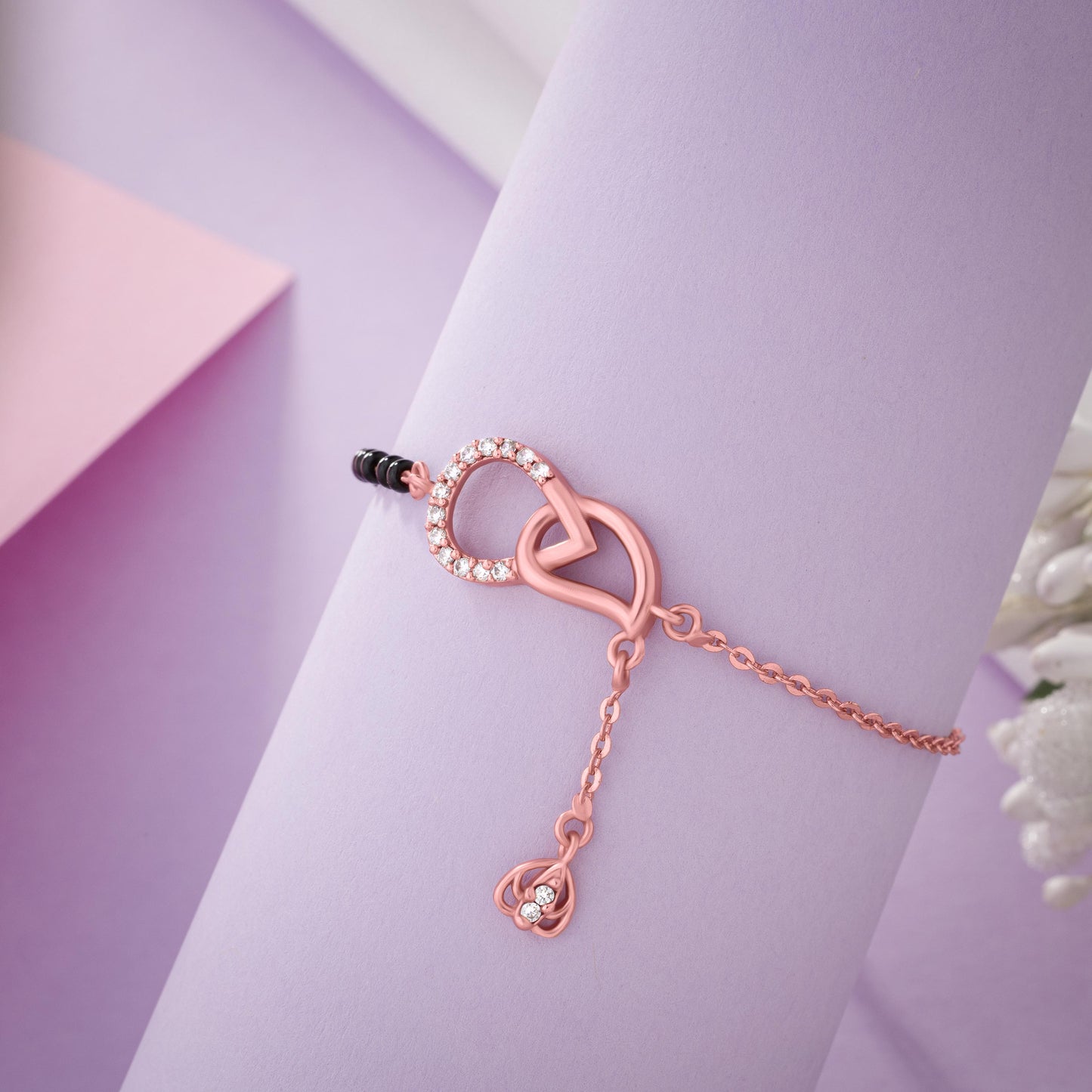 bracelet with a heart charm and a black bea