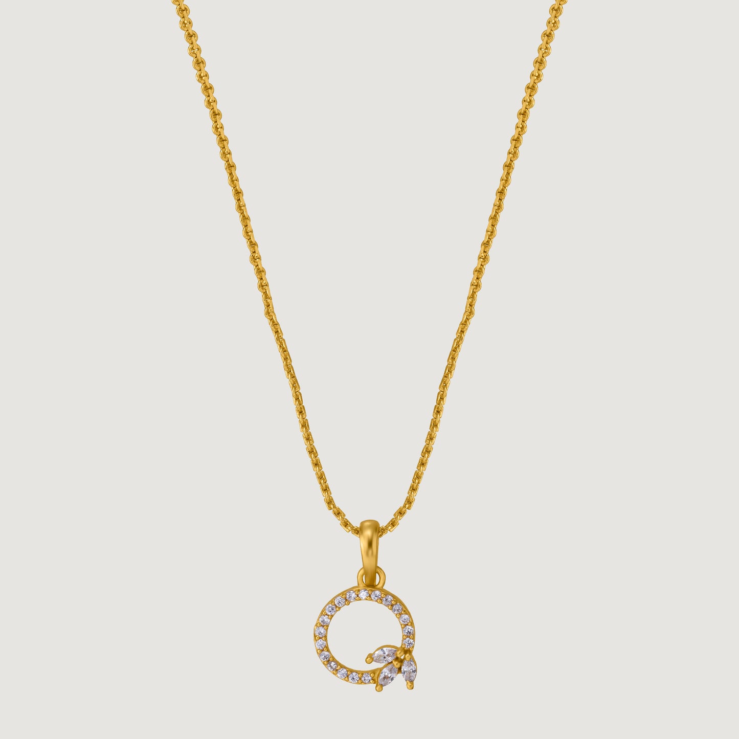 golden necklace with a diamond letter on it