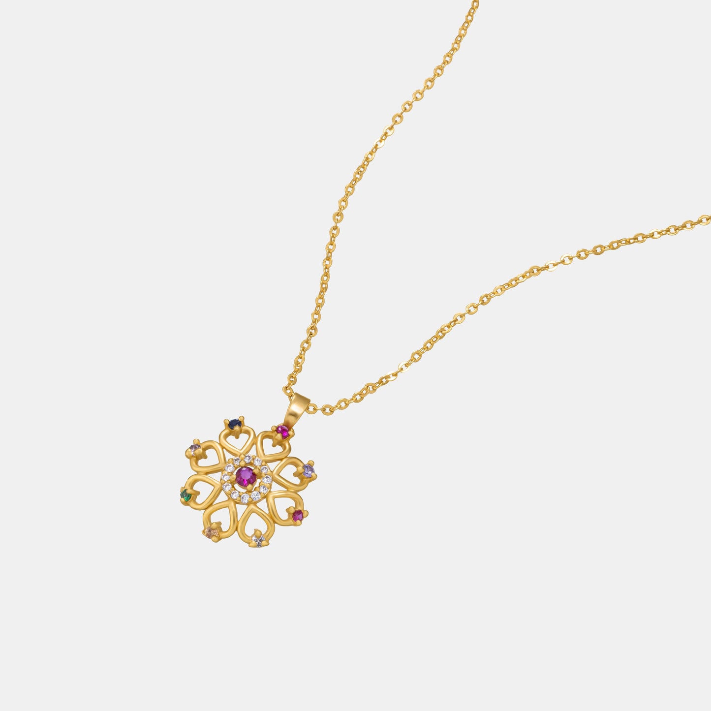 golden necklace with a flower design and multi colored stones