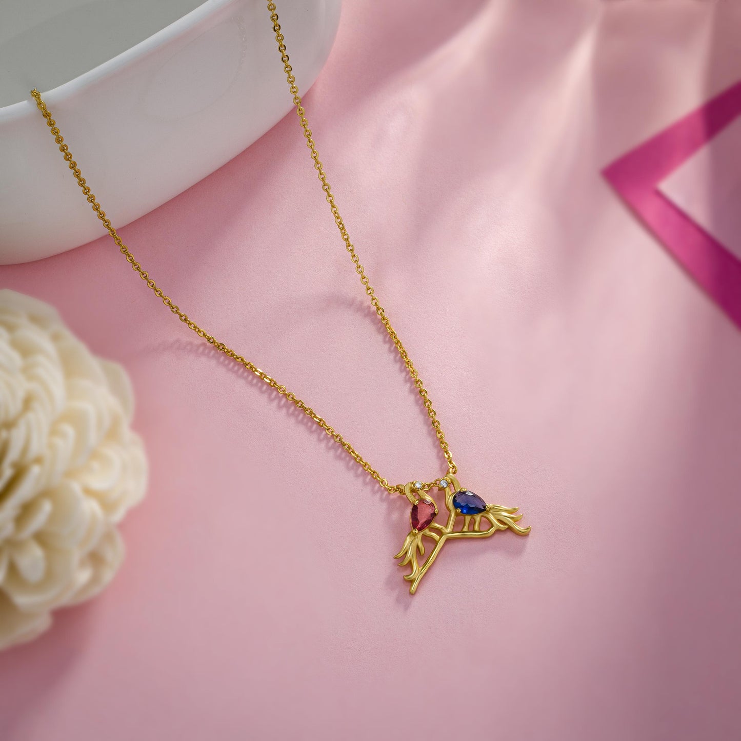 golden necklace with a bird and a heart