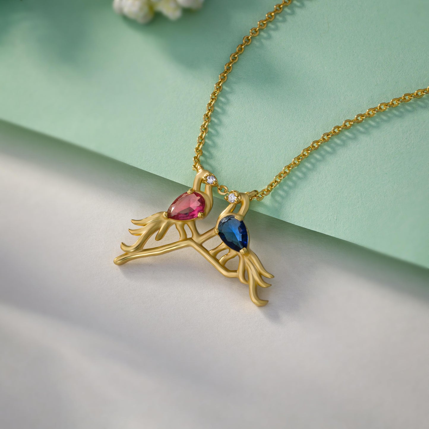 golden necklace with a bird and a heart