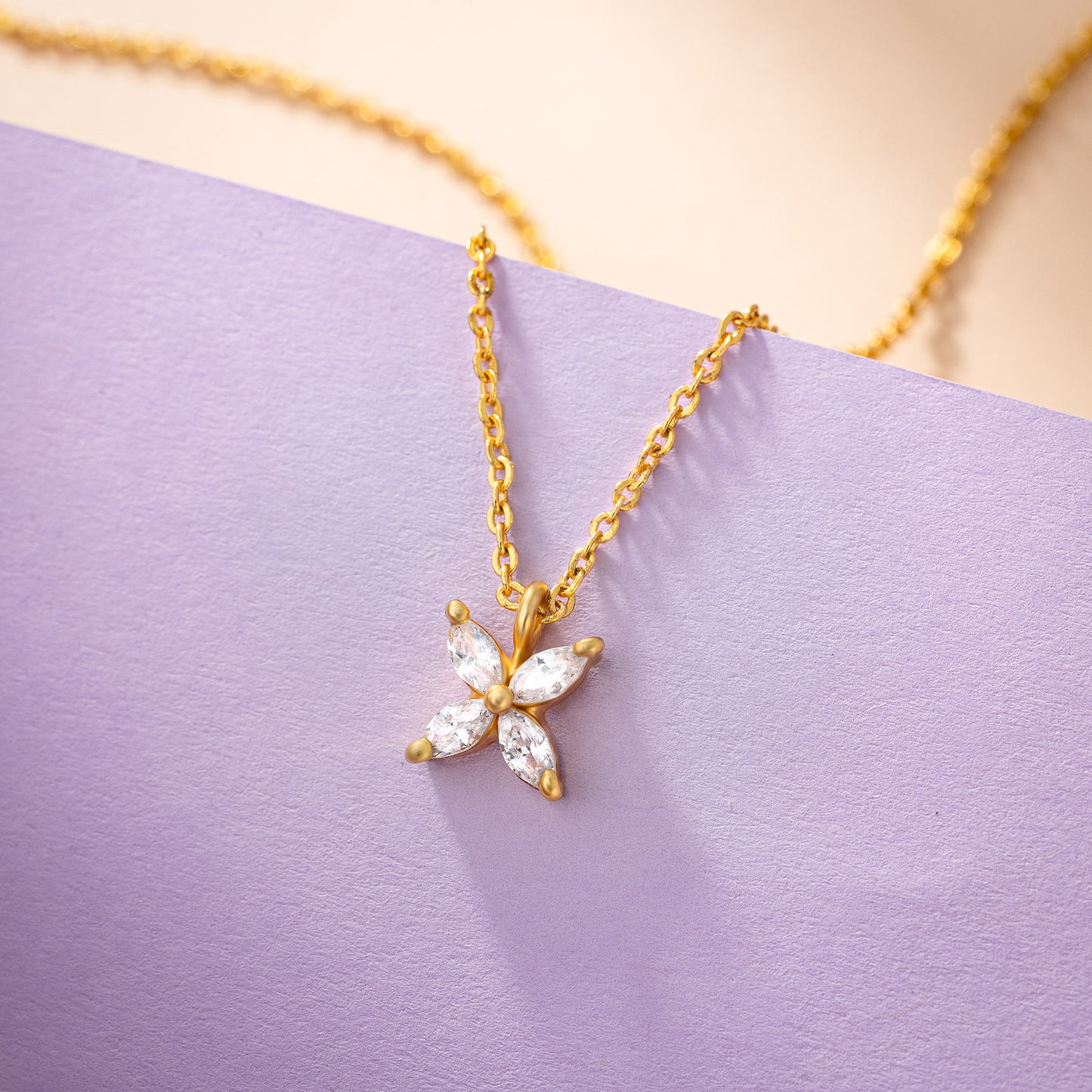 golden necklace with a small white diamond