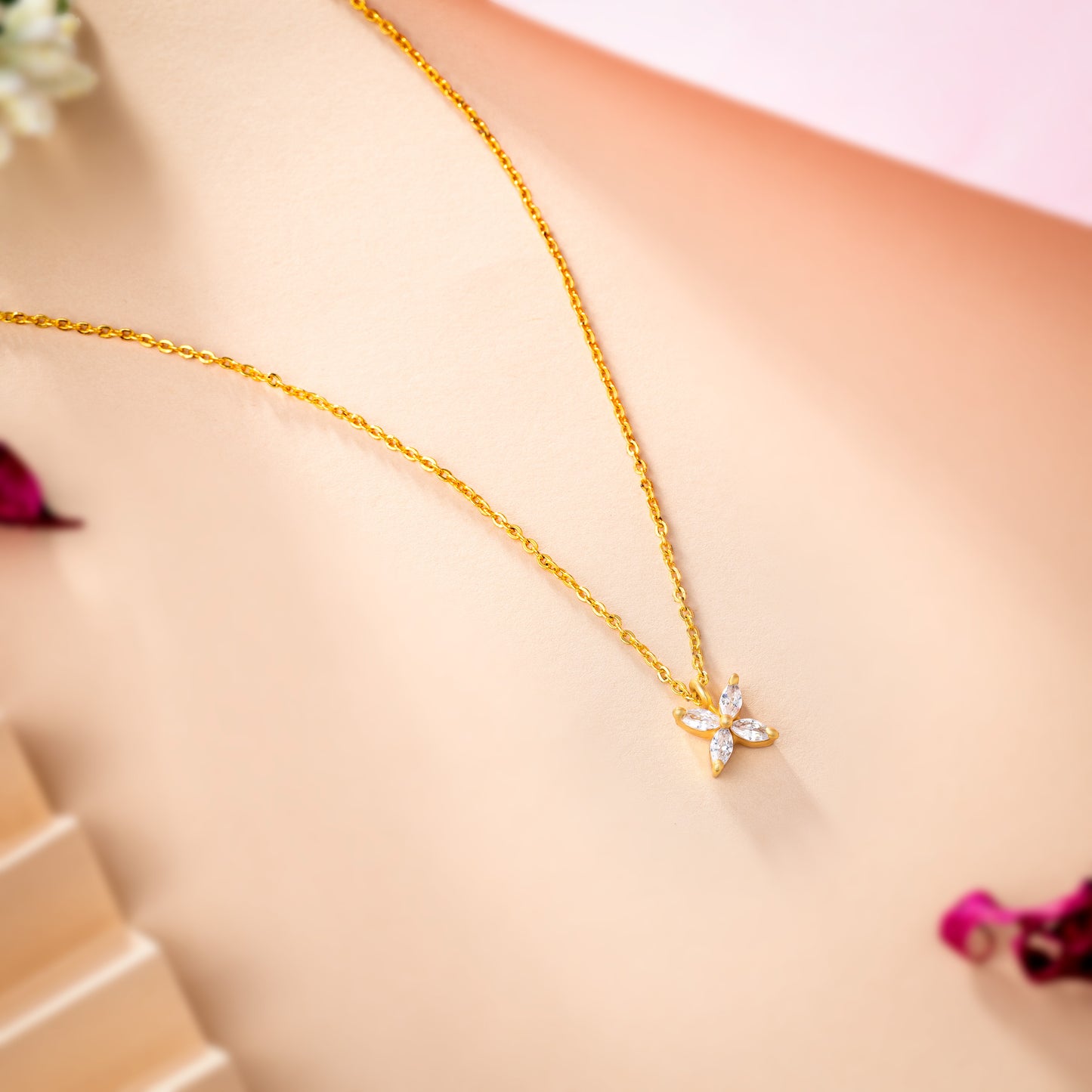 golden necklace with a small white diamond