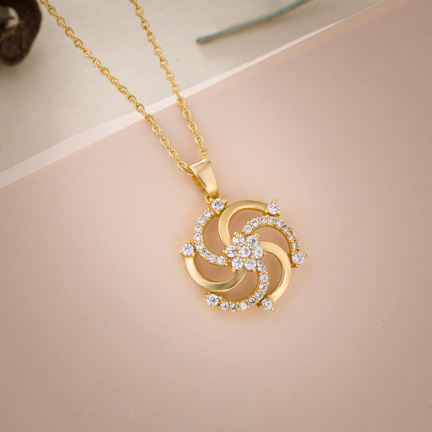 golden necklace with a diamond pendant