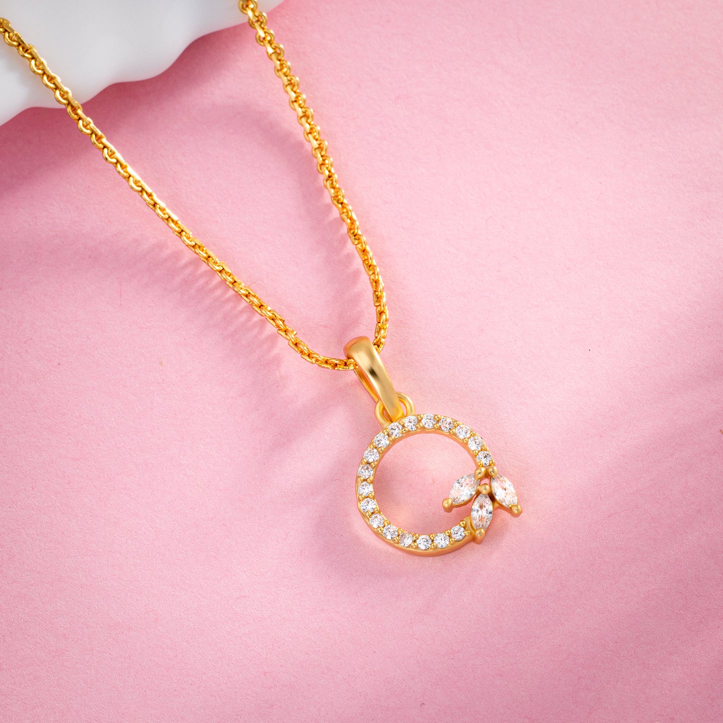 golden necklace with a diamond letter on it