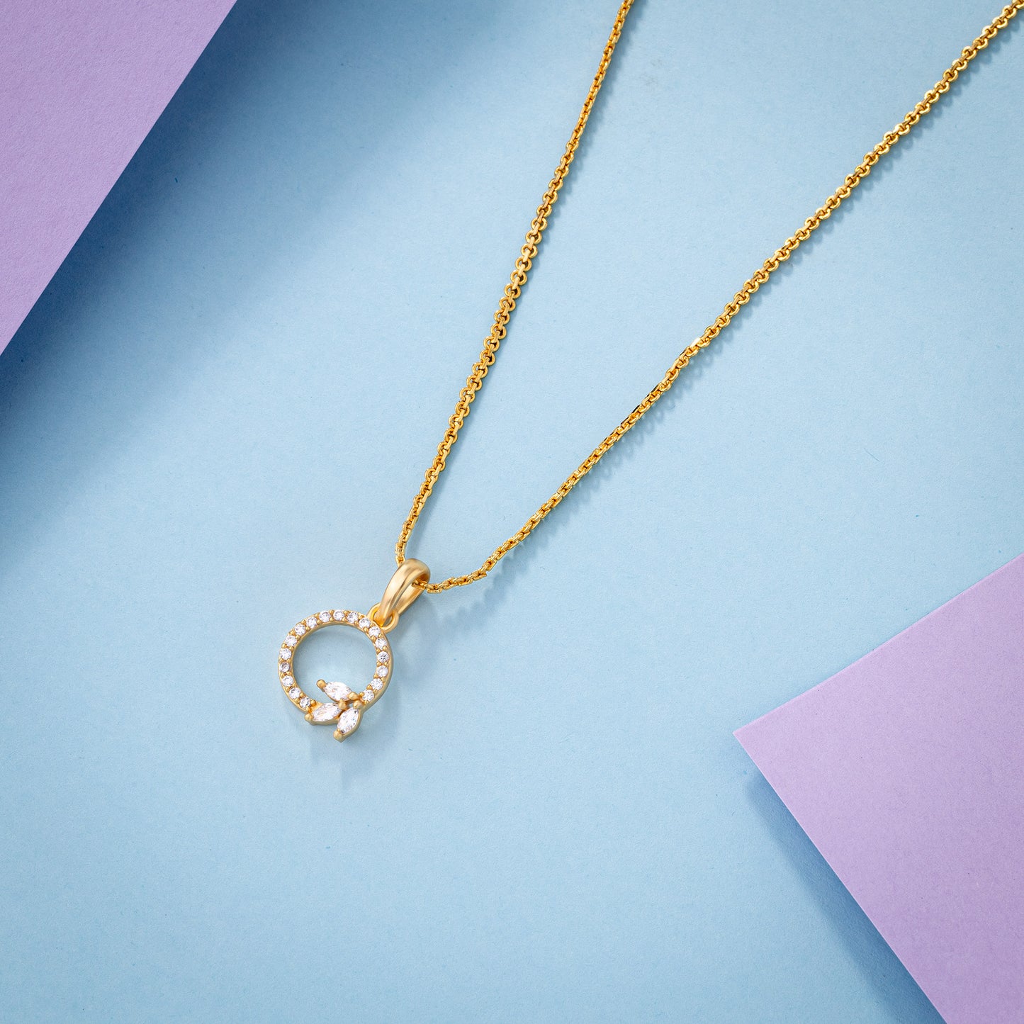 golden necklace with a diamond letter on it