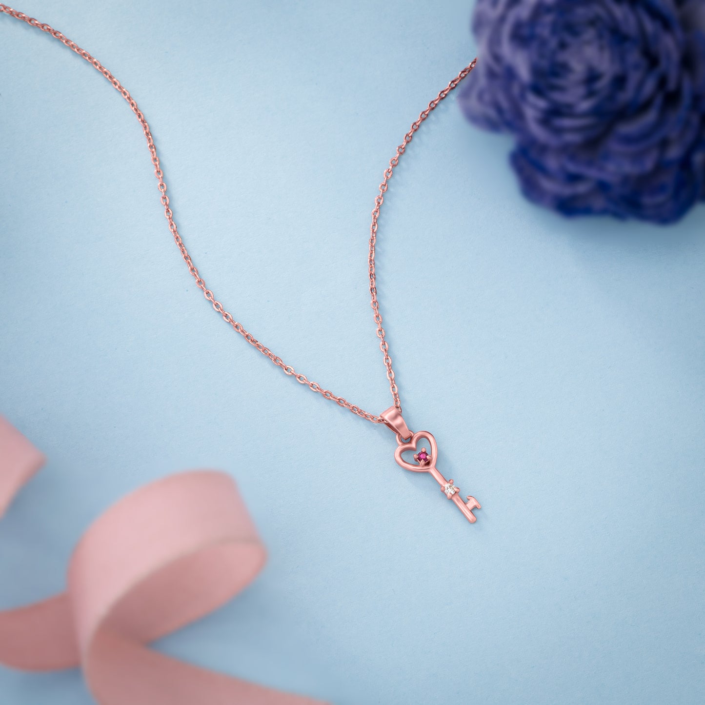 rose gold necklace with a heart and a key