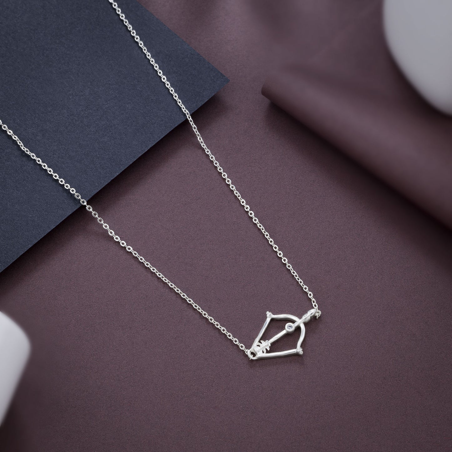 silver necklace with a small arrow on it