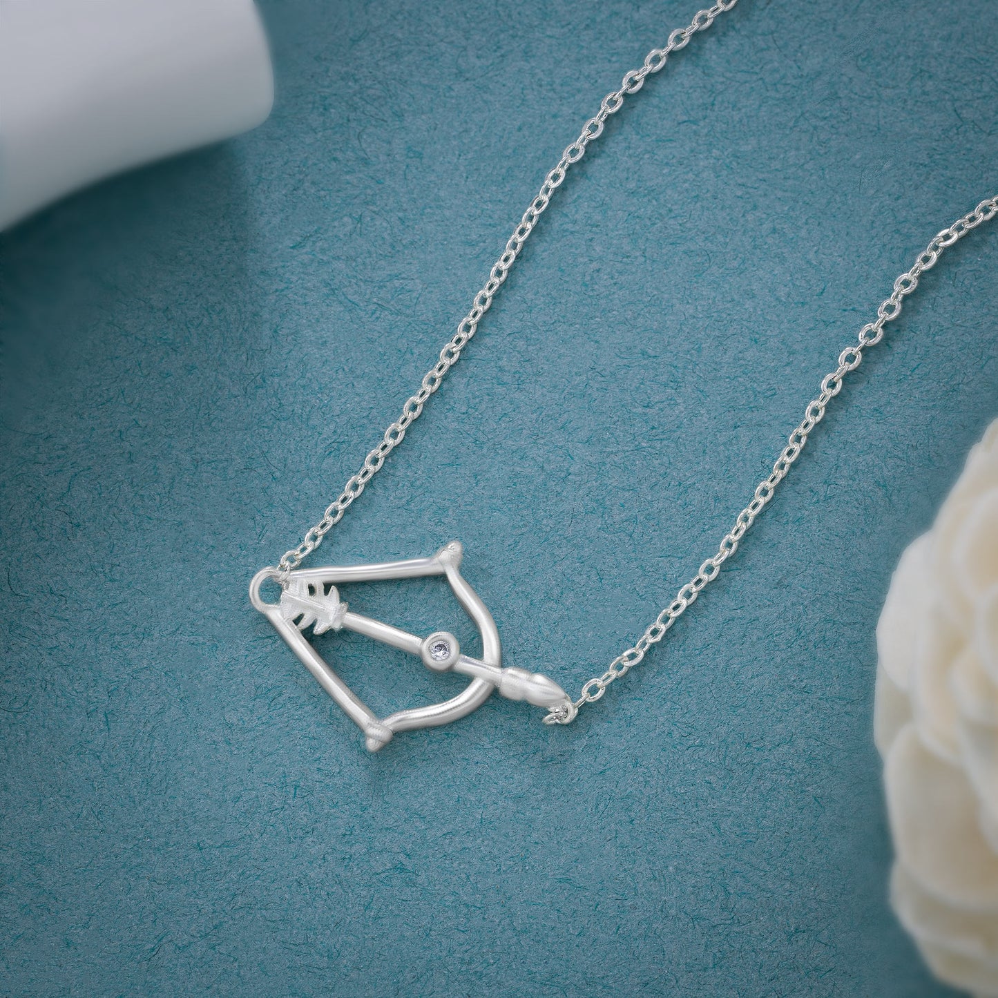 silver necklace with a small arrow on it