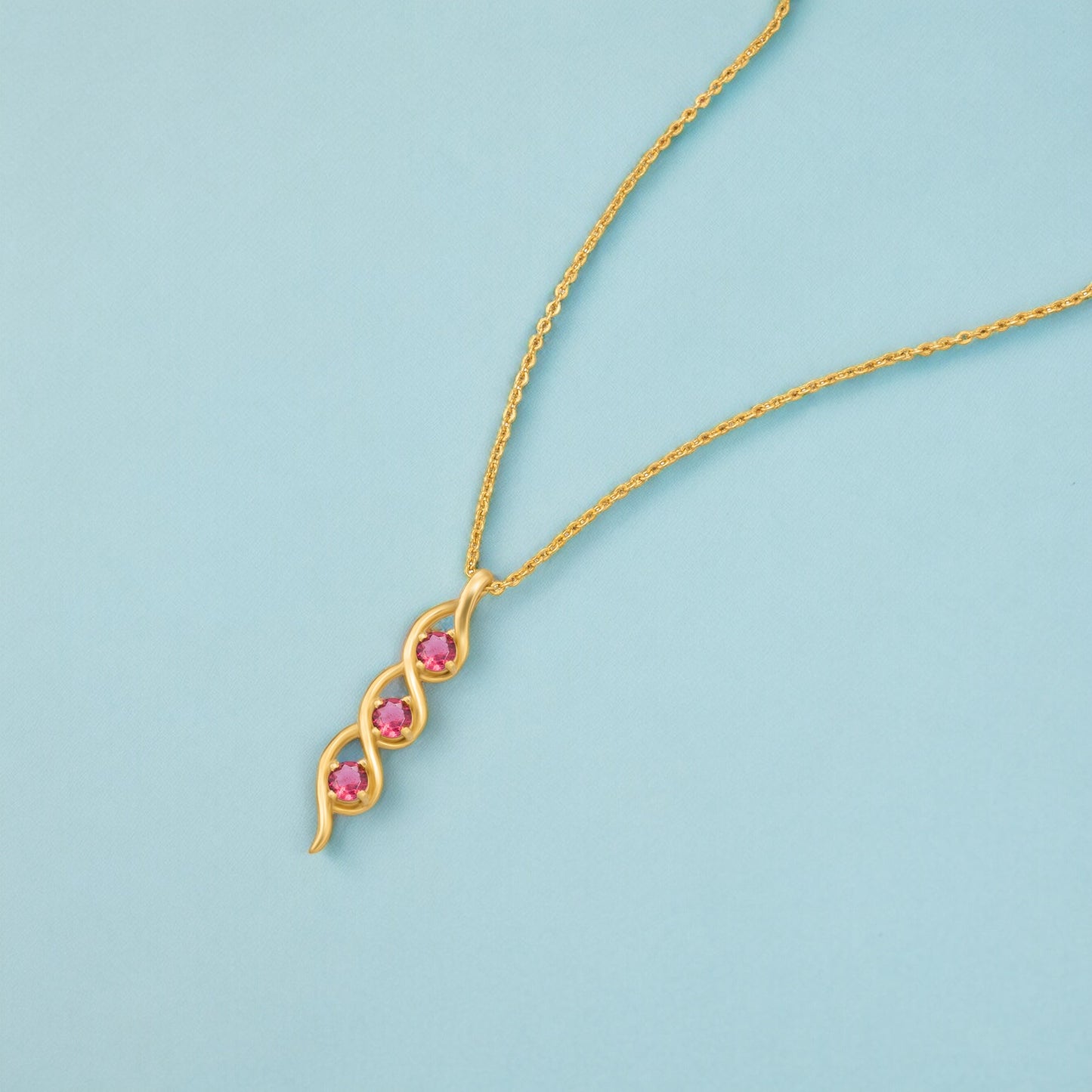 golden necklace with a rainbow stone pendant