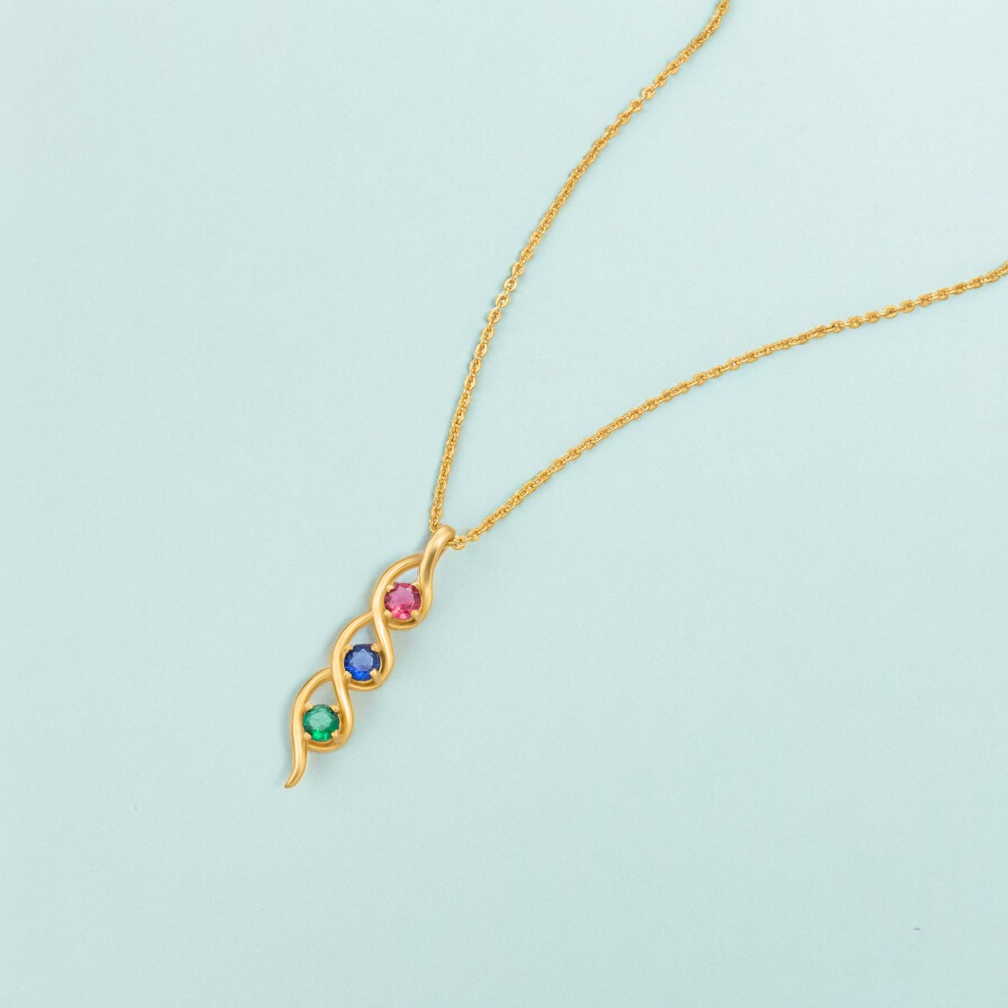 golden necklace with a rainbow stone pendant