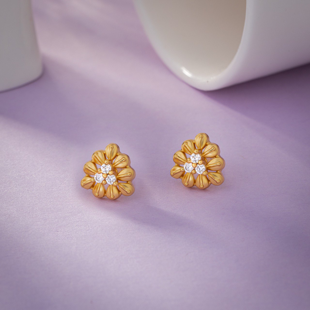 pair of golden and flower earrings