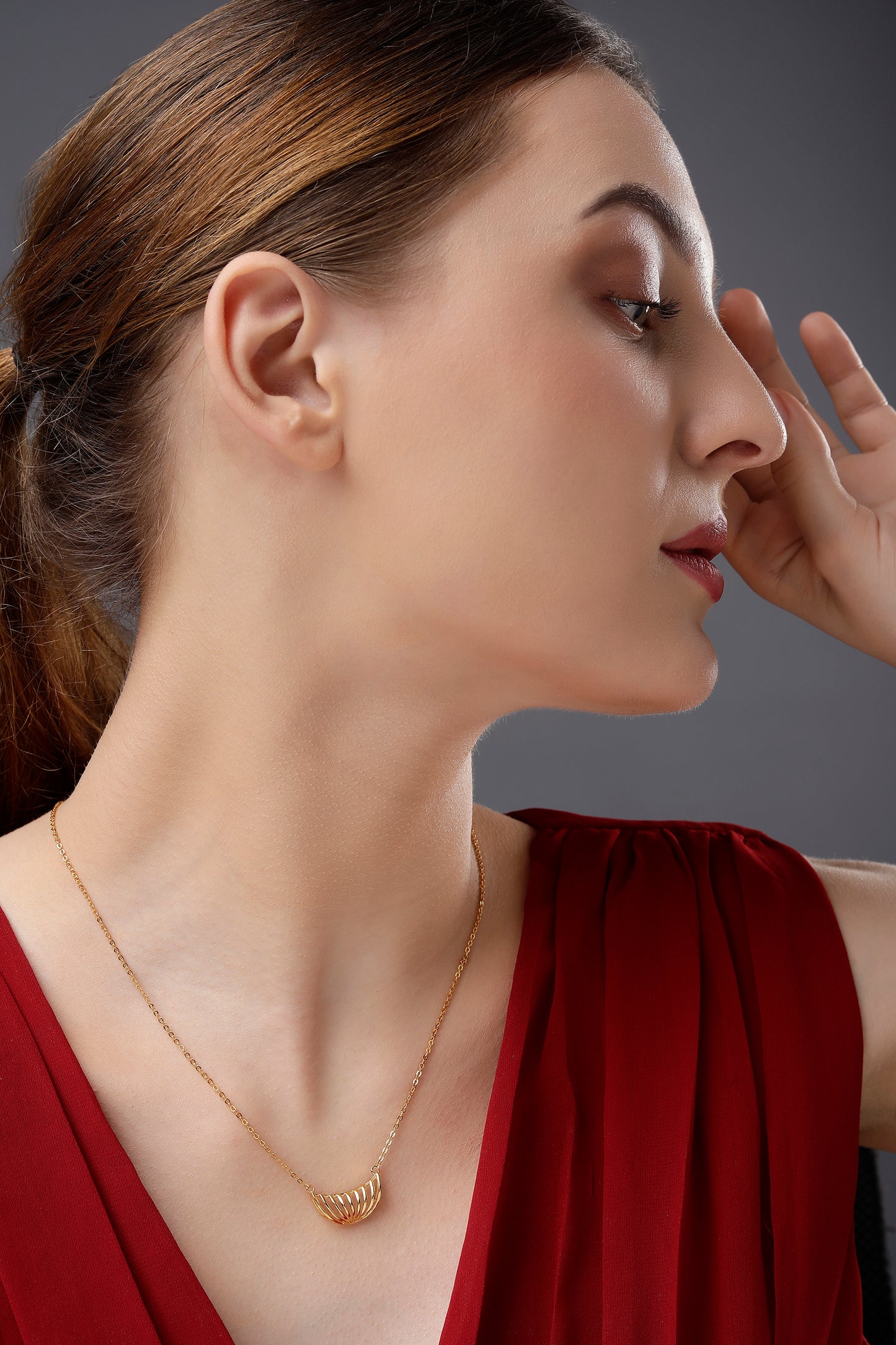 golden necklace with a large curved design