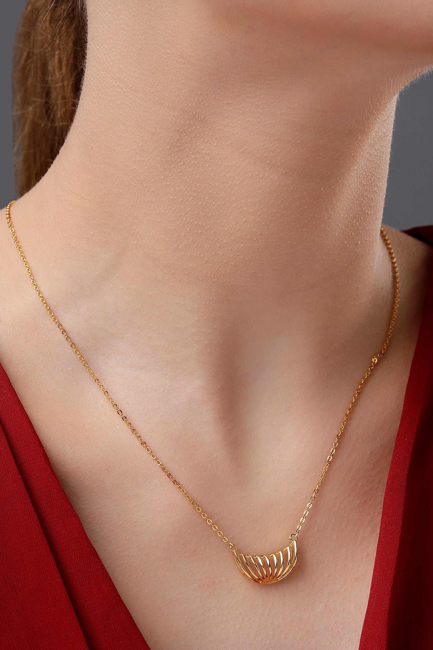 golden necklace with a large curved design