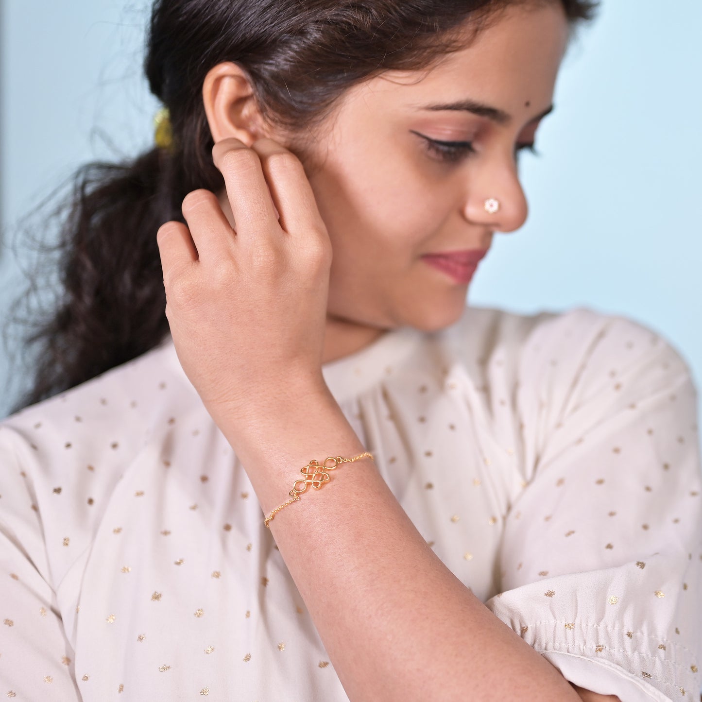 golden bracelet with a beautiful knot