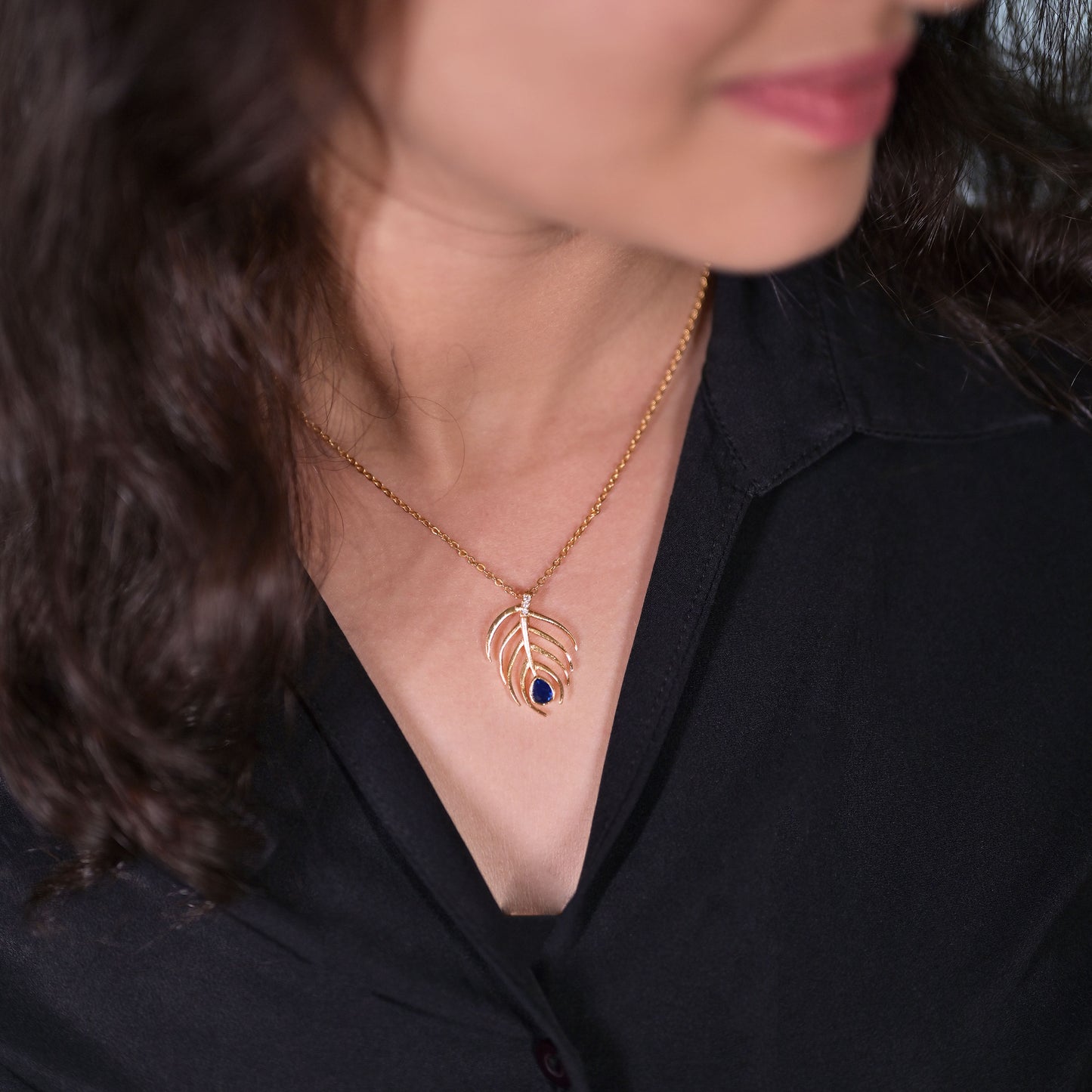 golden necklace with sapphire stone