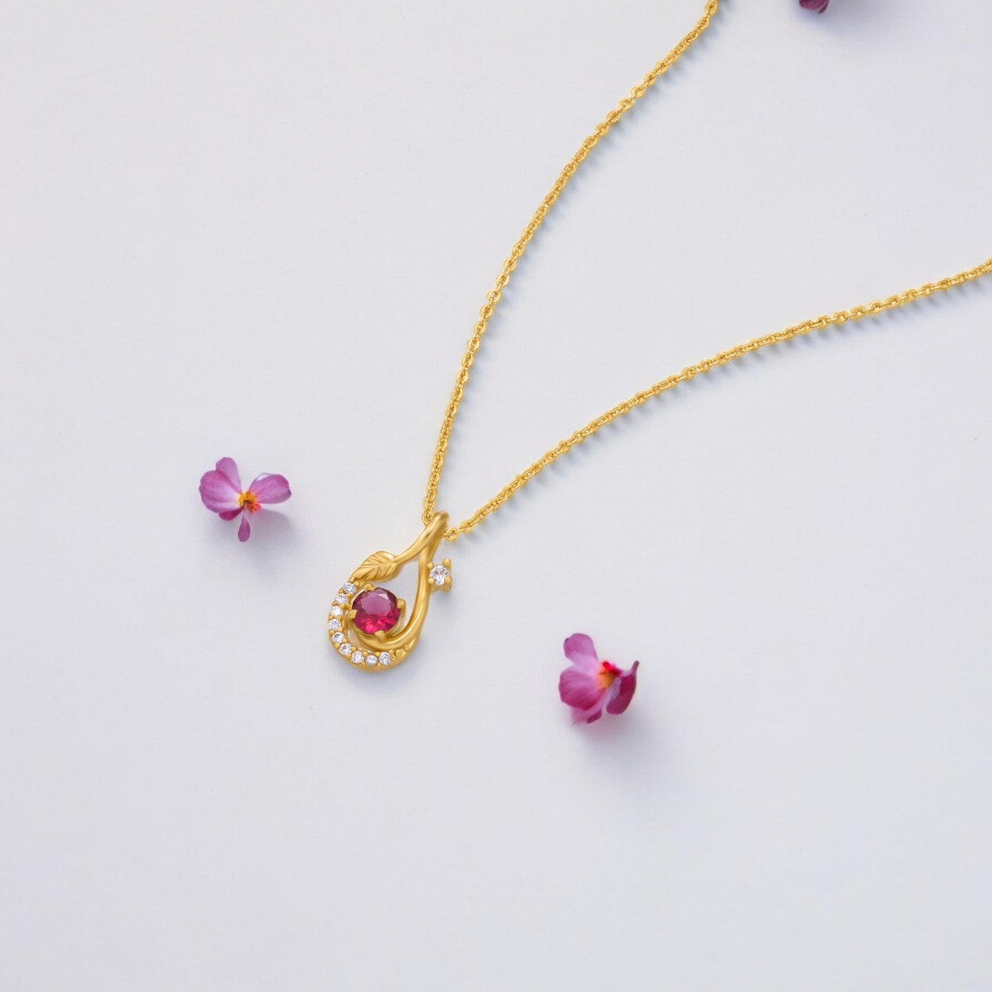 golden necklace with a stone and diamonds