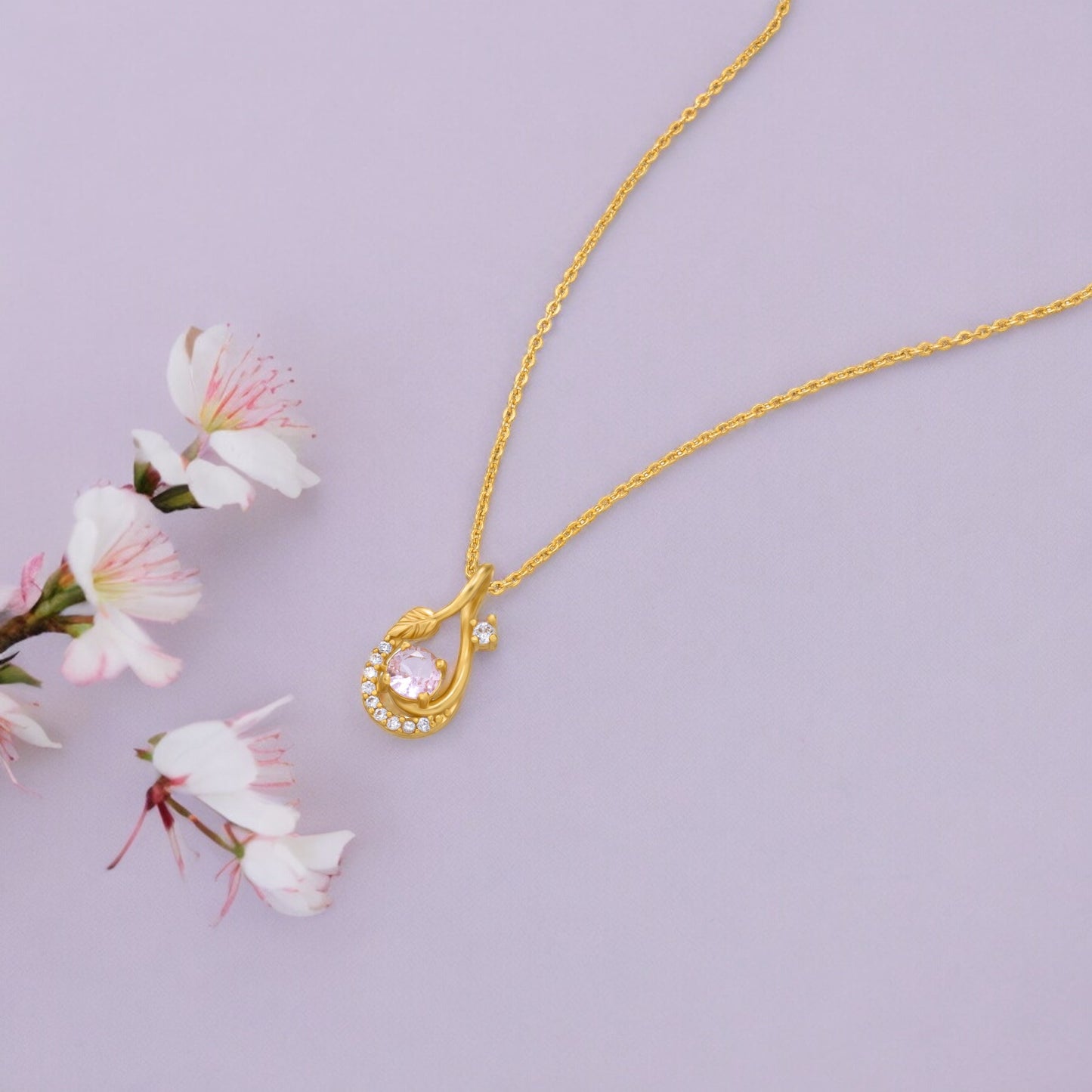 golden necklace with a stone and diamonds