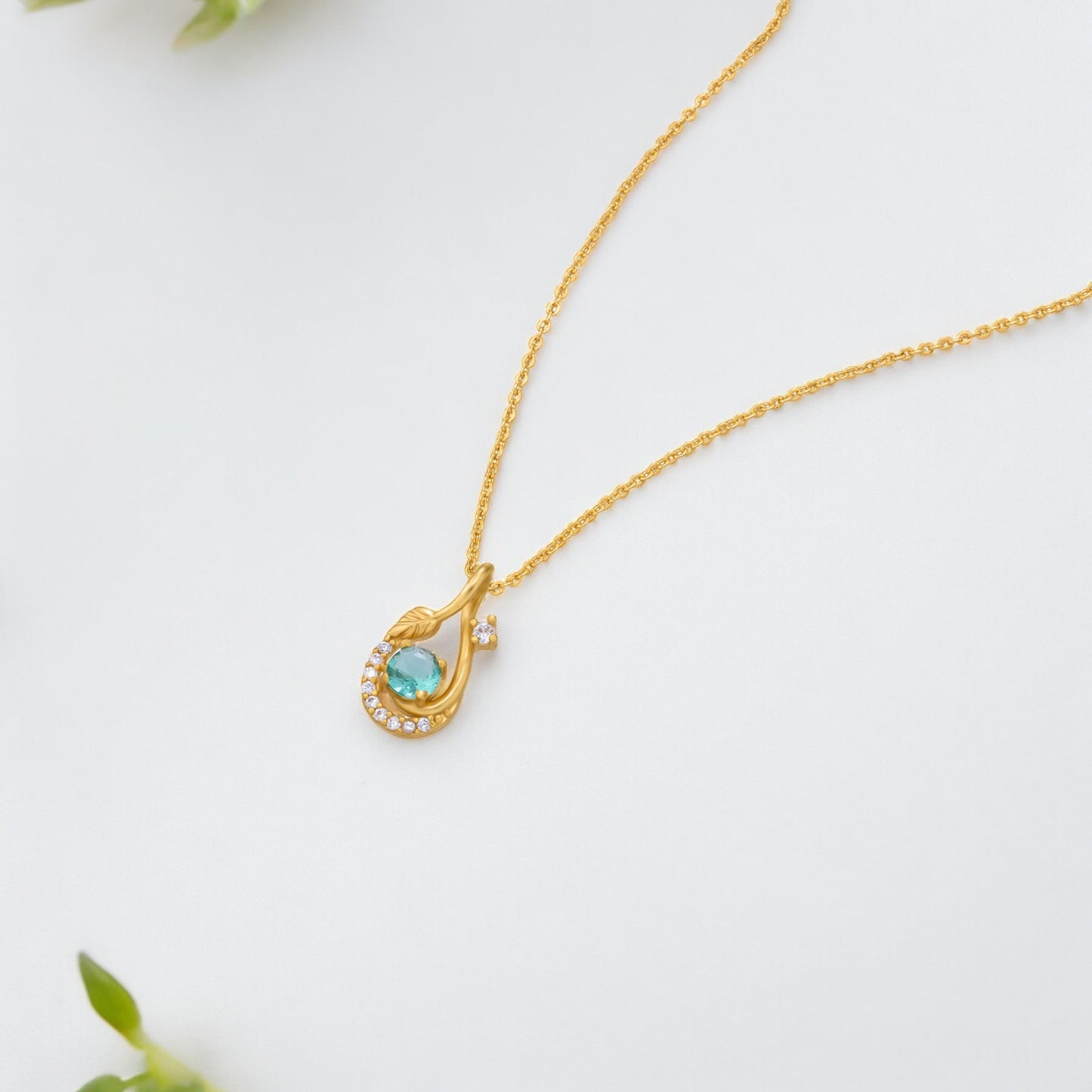 golden necklace with a stone and diamonds