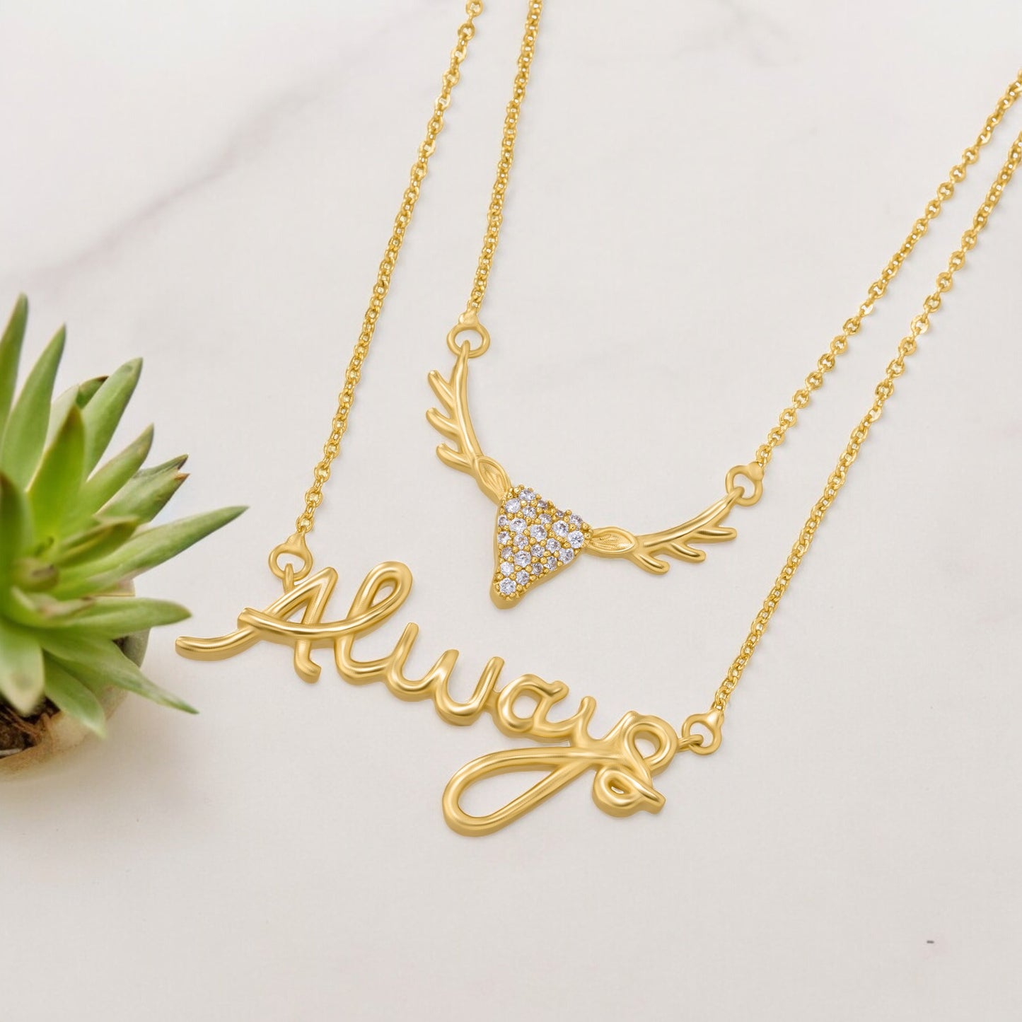 golden necklace with a deer head and the word love