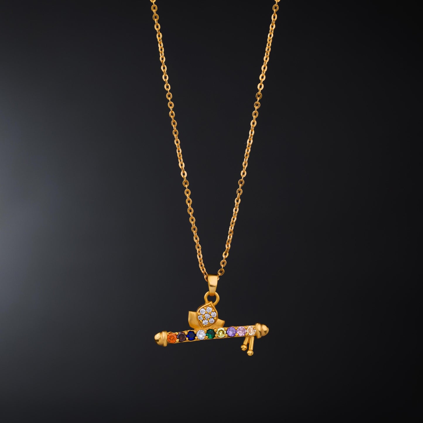 golden necklace with a flute pendants