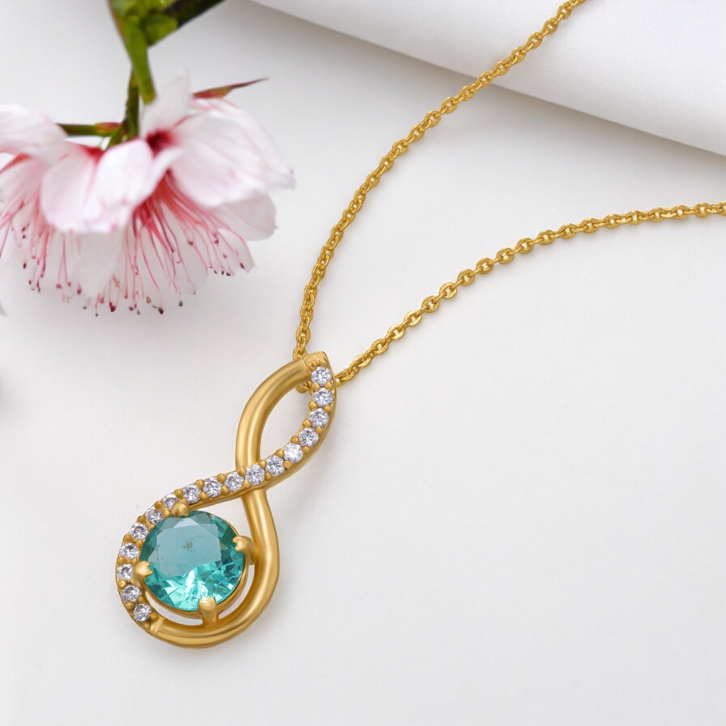 golden necklace with a stone and diamonds