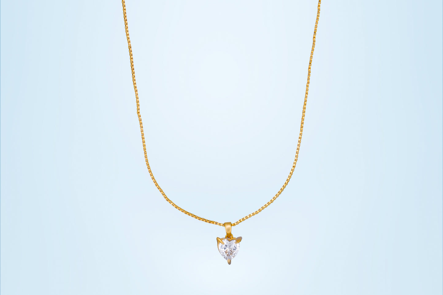 golden necklace with white heart pendant