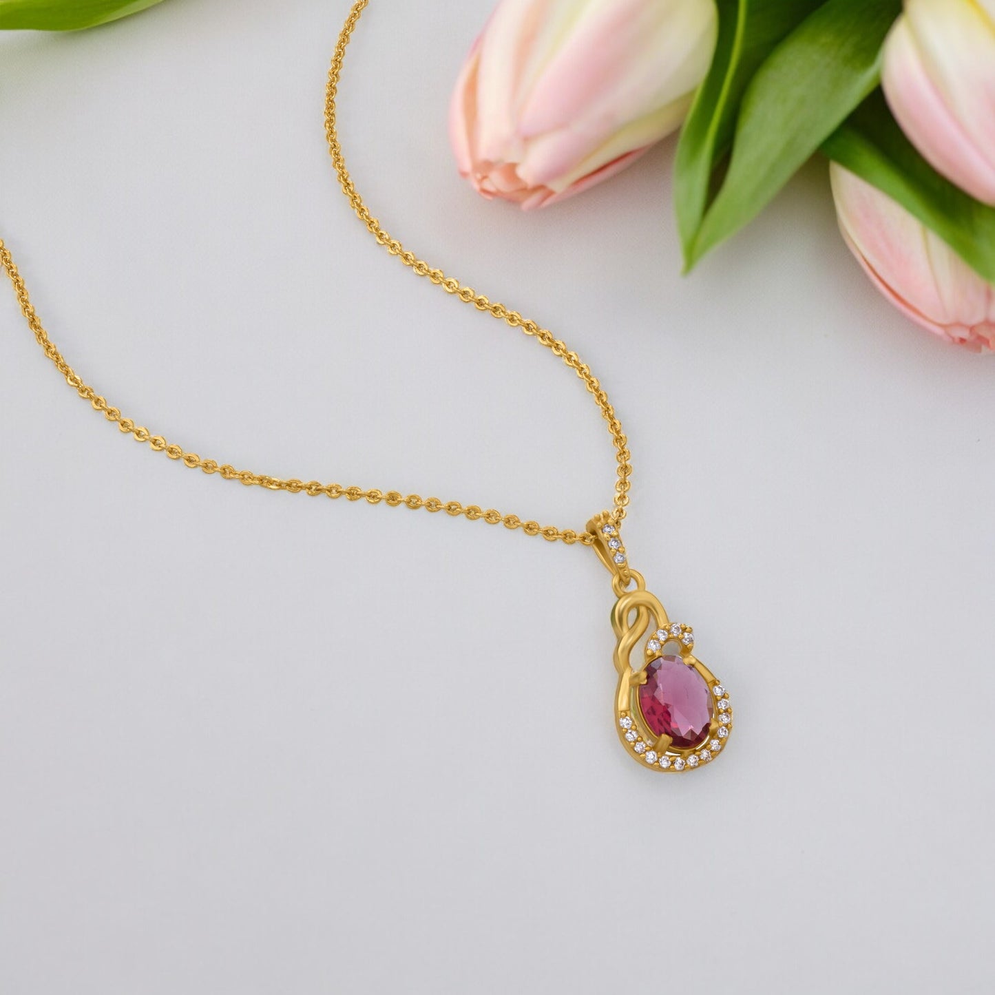 golden necklace with a stone and diamonds