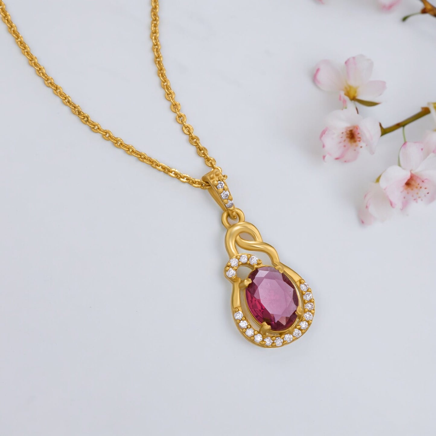 golden necklace with a stone and diamonds