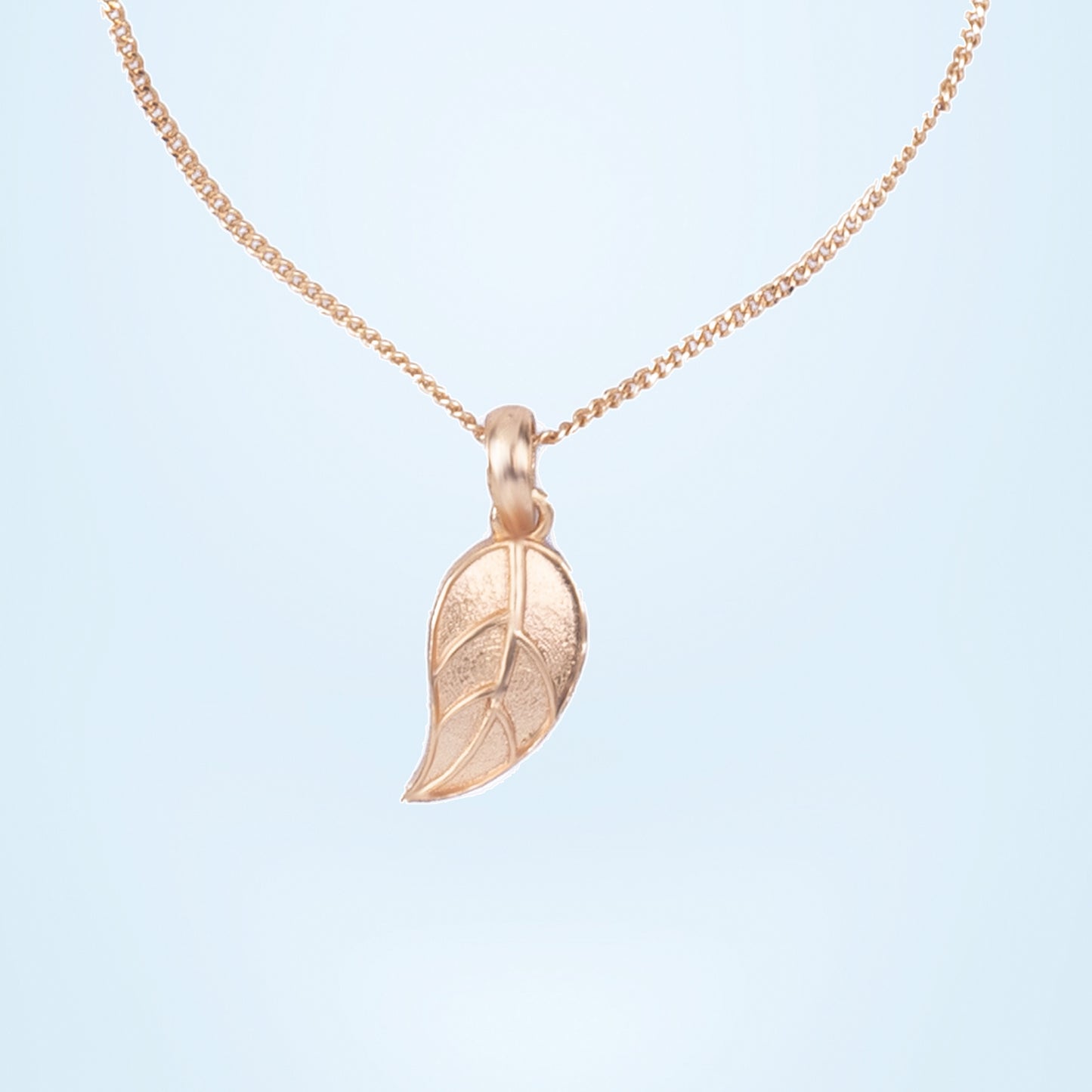 golden necklace with leaf pendant