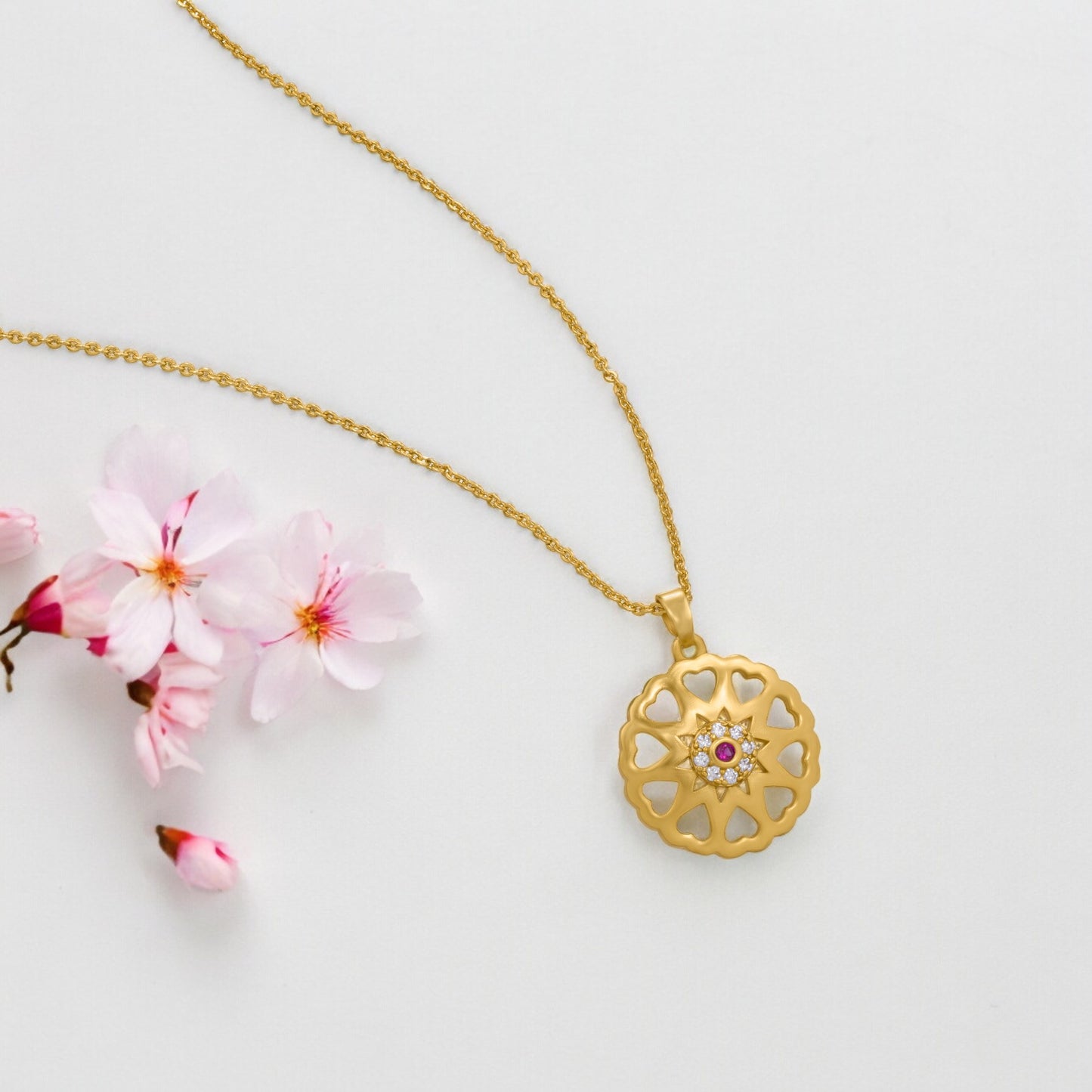 golden necklace with a flower design on it