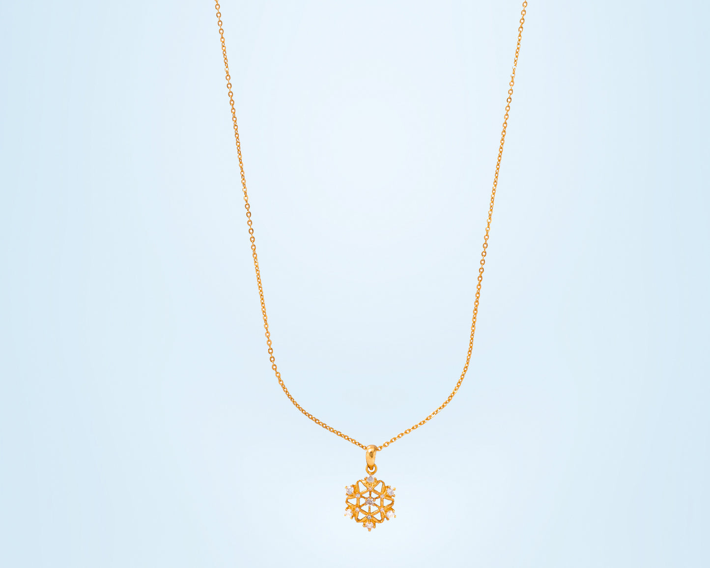 golden necklace with a diamond pendant