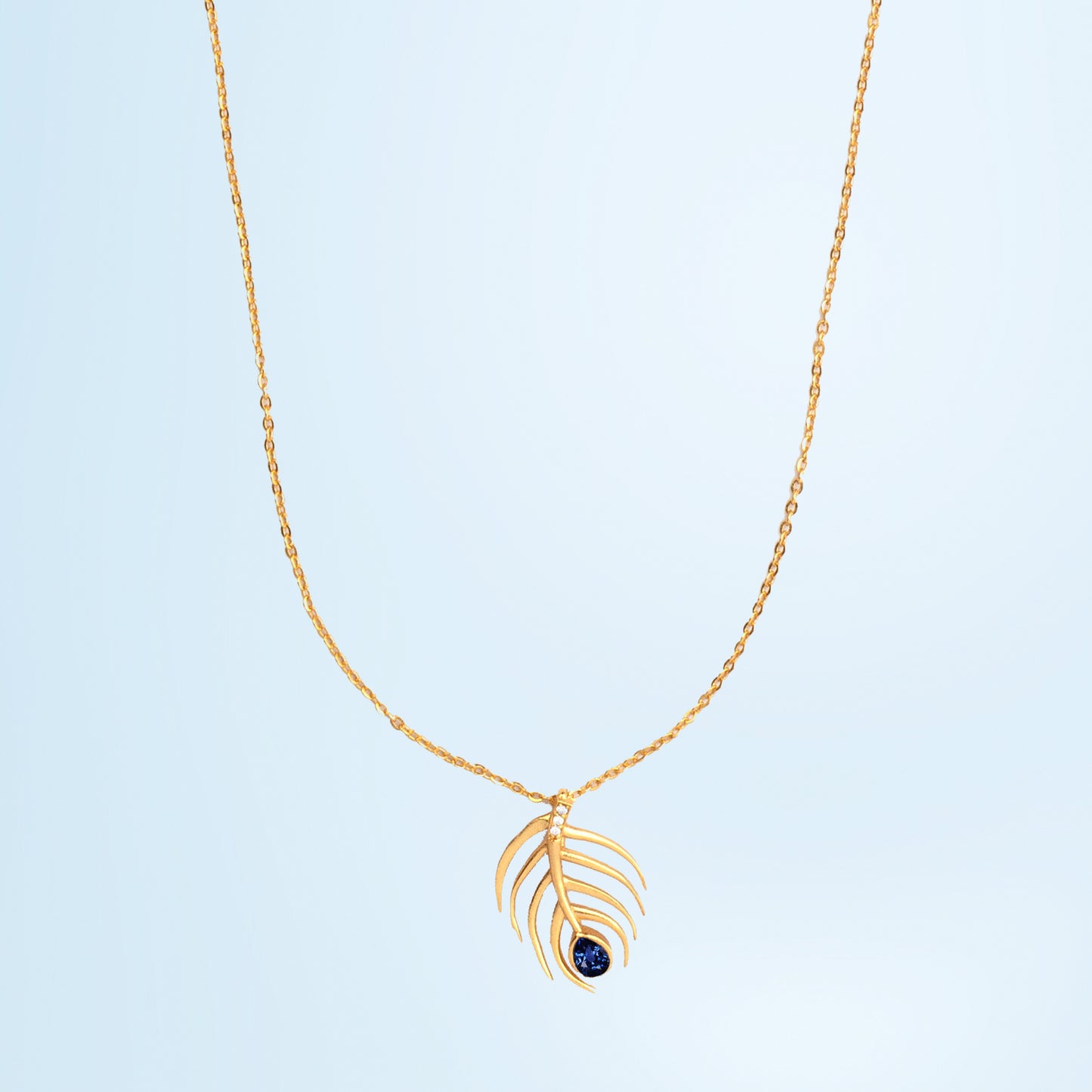 golden necklace with sapphire stone