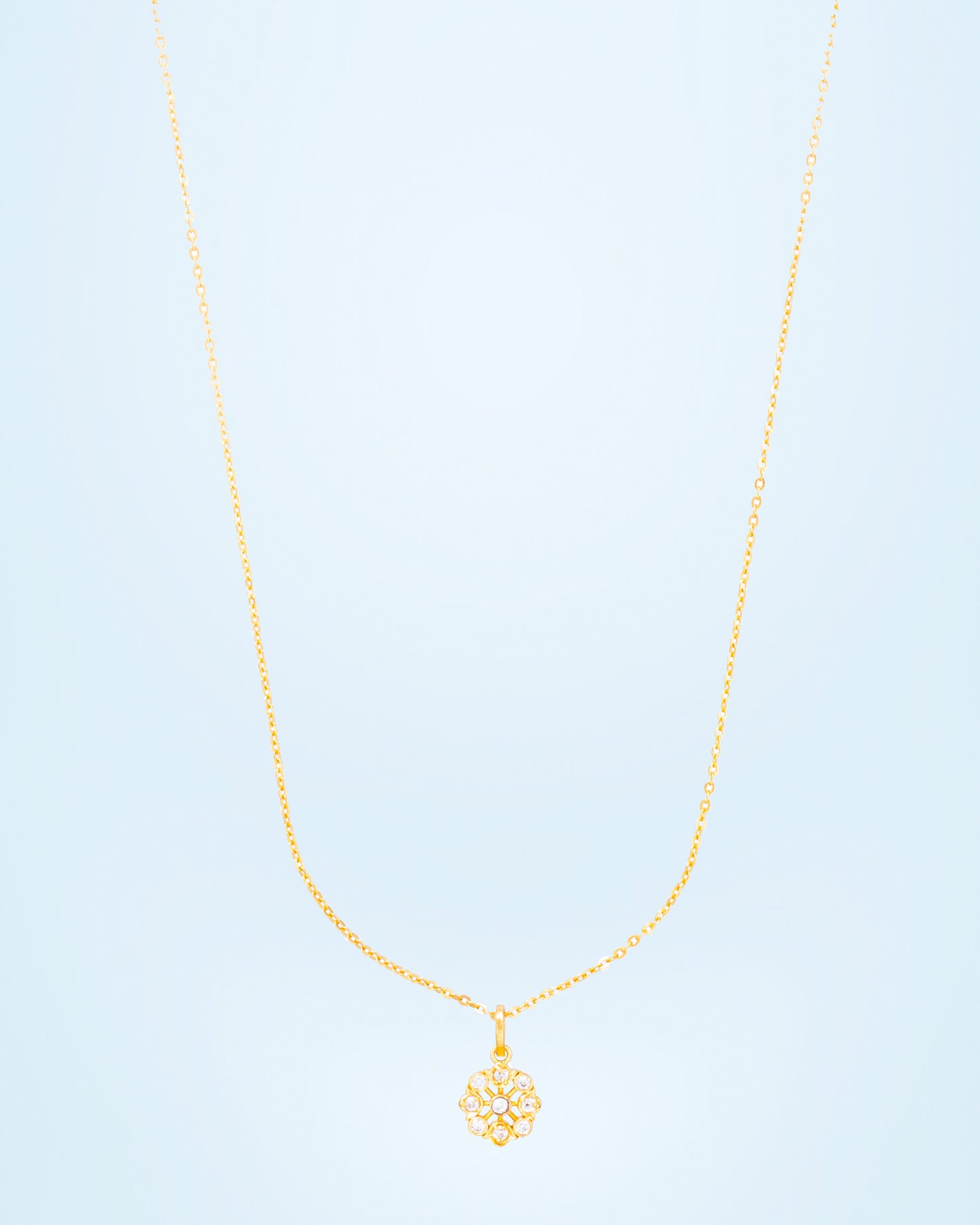 golden flower necklase with white stones