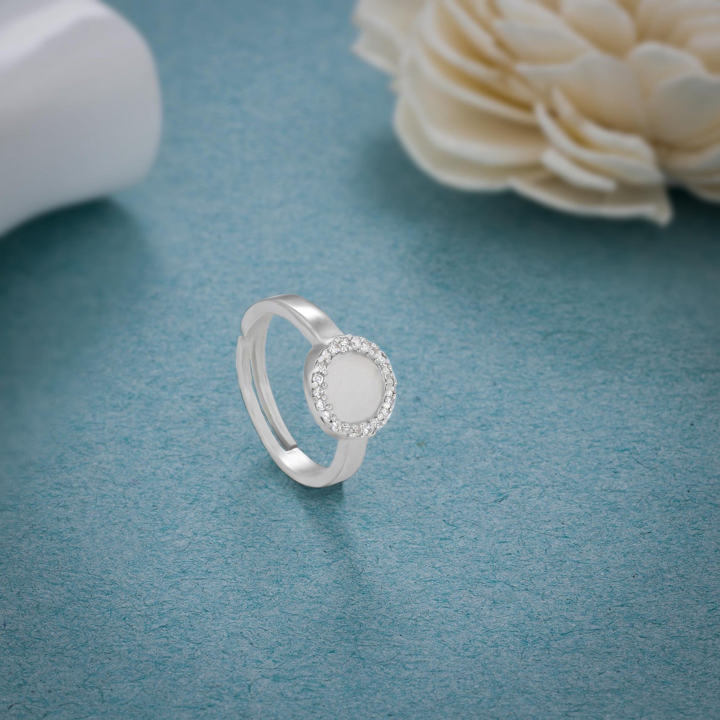 silver ring with a diamond and a small round stone