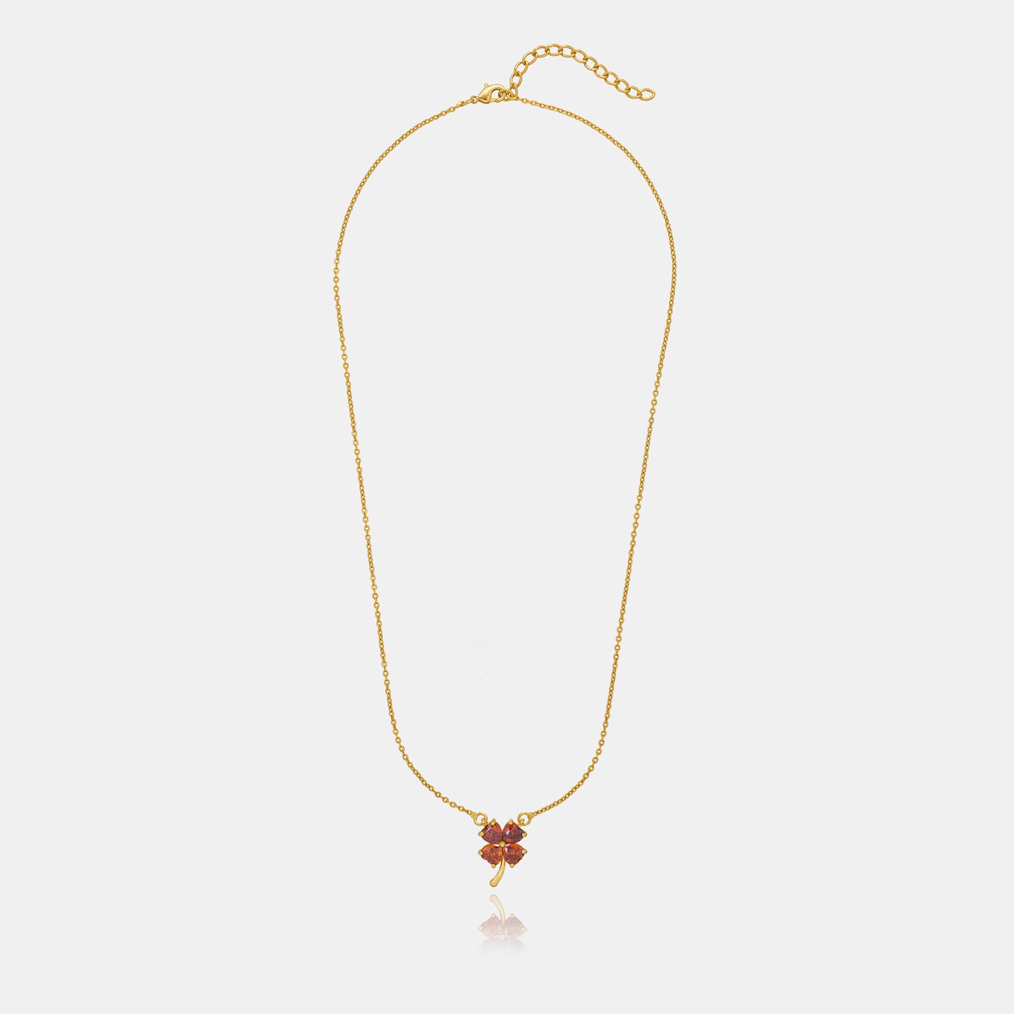 golden necklace featuring a four-leaf clover pendant