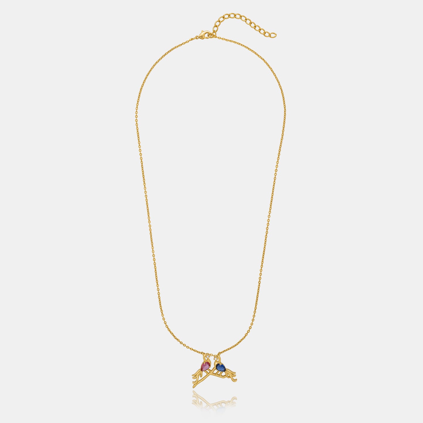 golden necklace with a bird and a heart