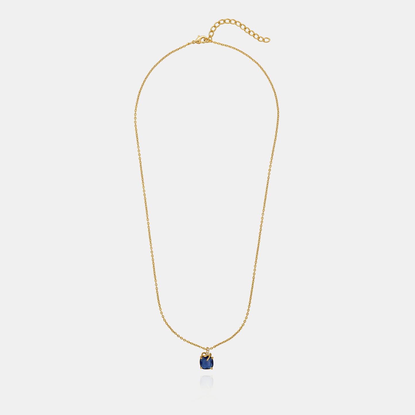 golden necklace with a sapphire stone