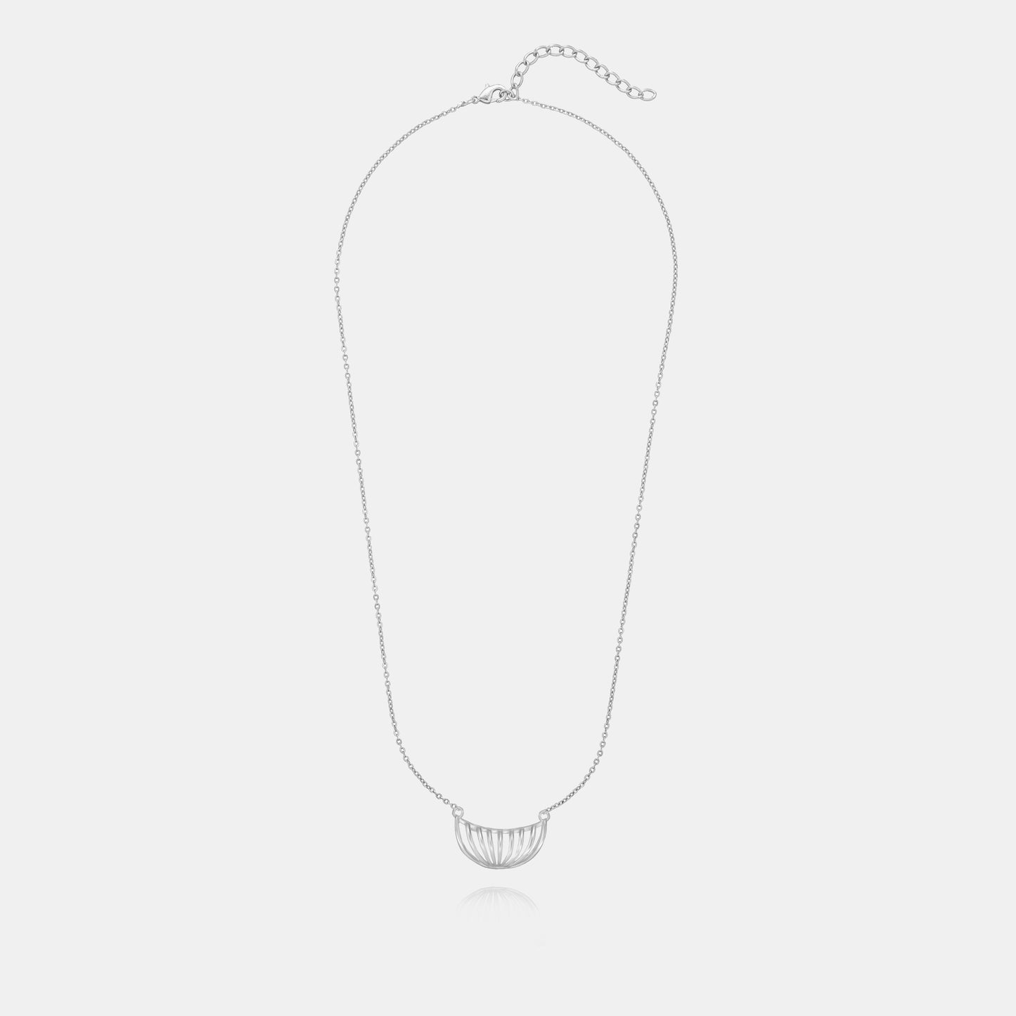 silver necklace with a large curved design