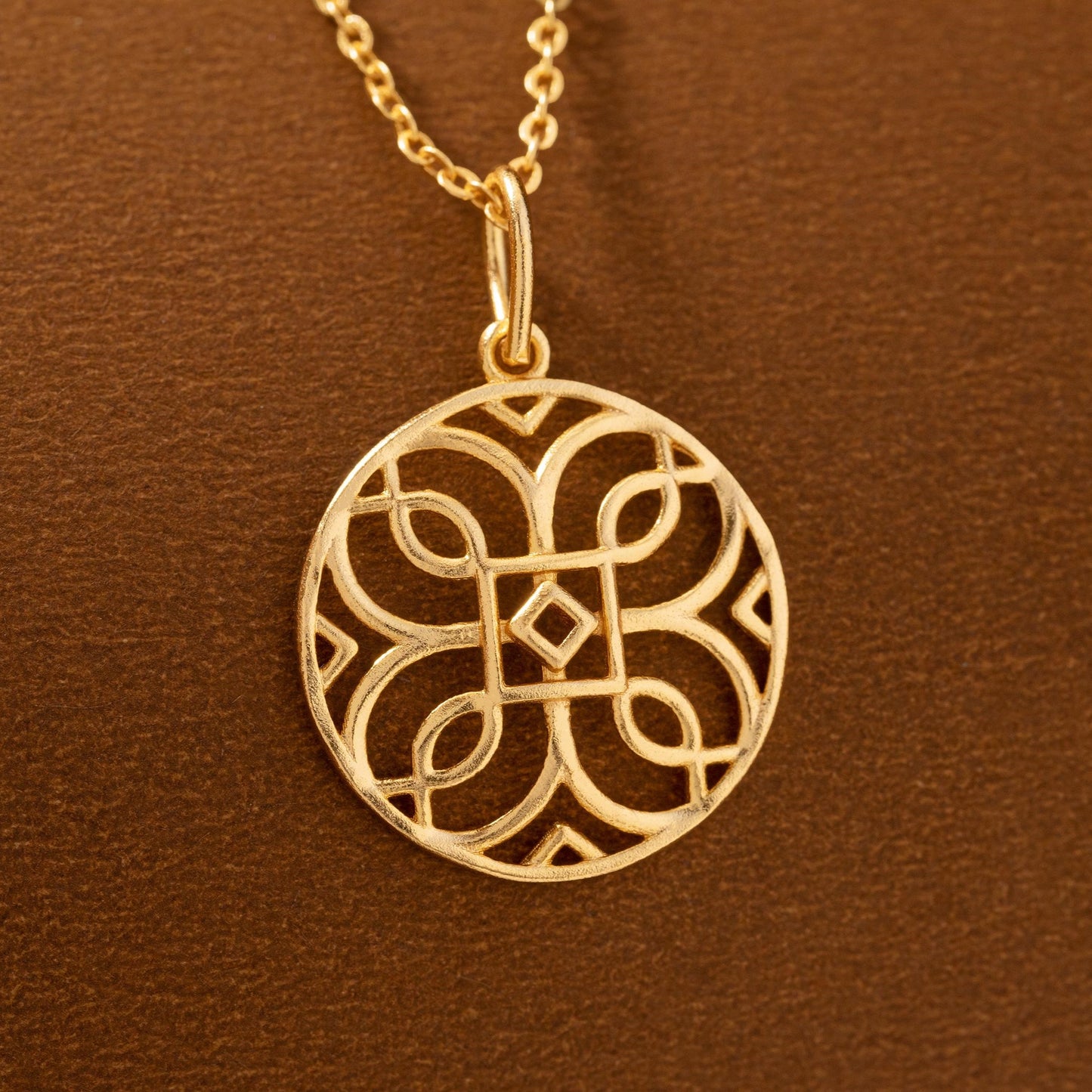 golden necklace with a celtic design pendant