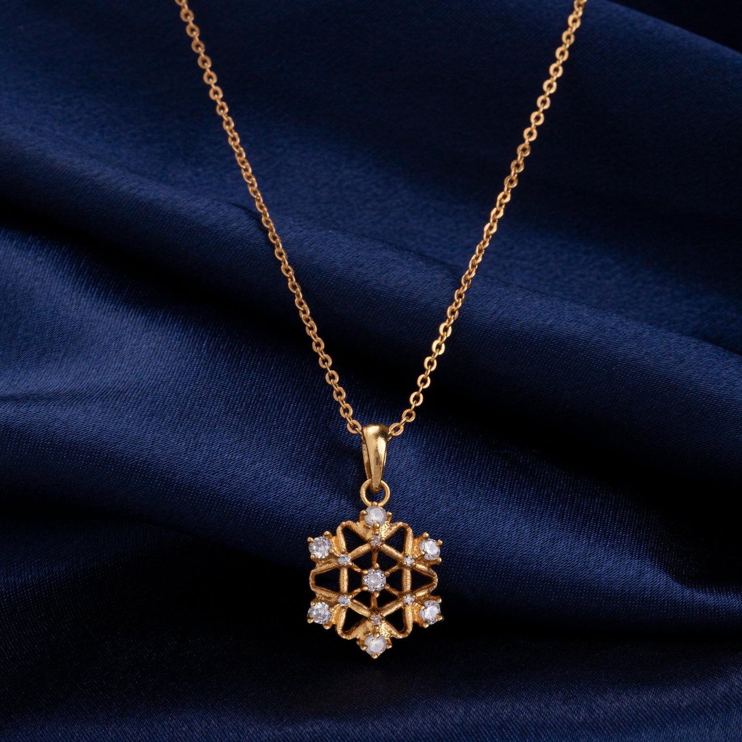 golden necklace with a diamond pendant