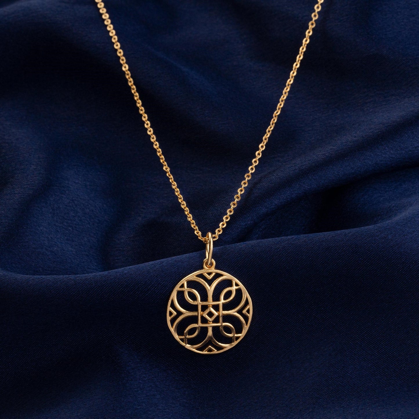 golden necklace with a celtic design pendant