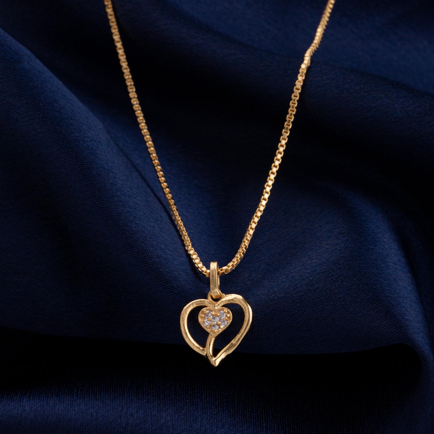 golden necklace with heart pendant